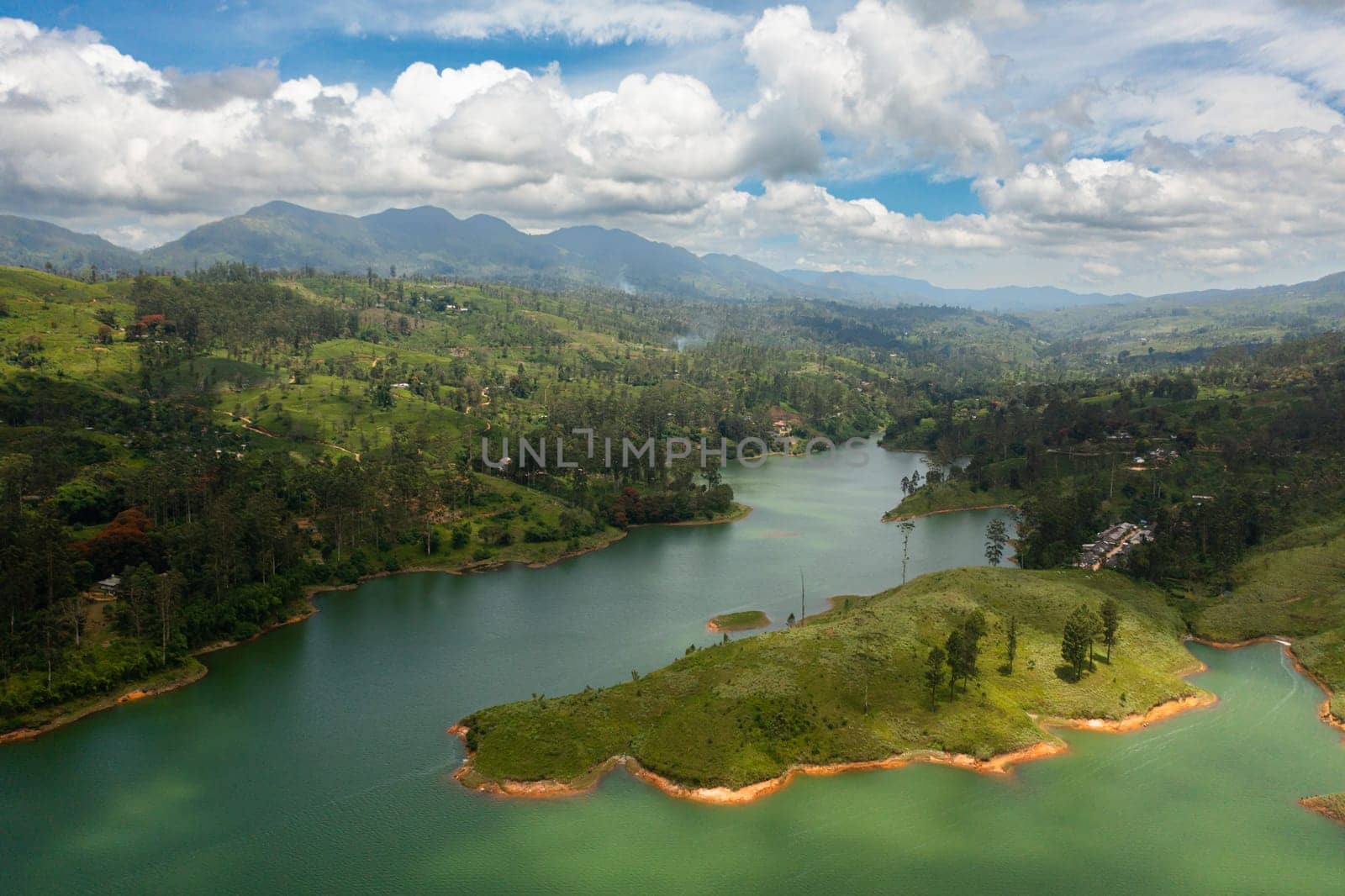 A lake among the hills with tea plantations in the mountains. Maskeliya, Castlereigh, Sri Lanka.