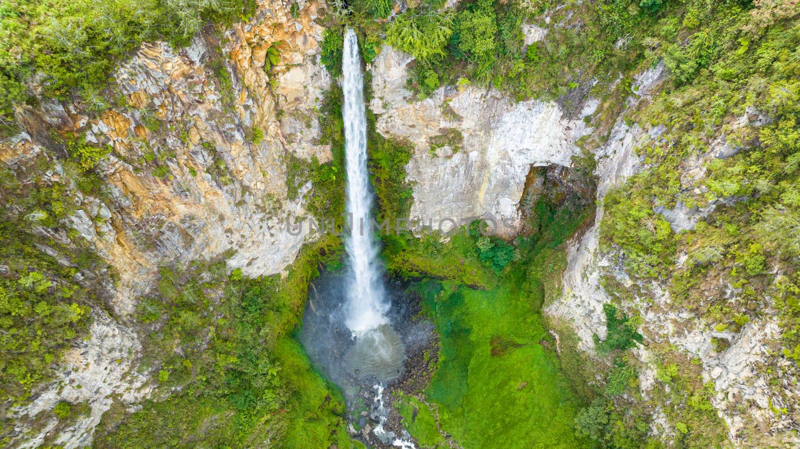 Beautiful waterfall in green forest. Sipiso Piso Falls in mountain jungle. Sumatra, Indonesia.