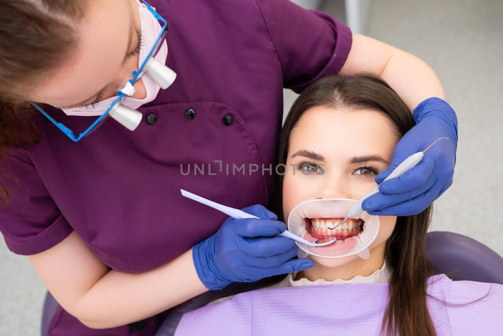 Happy woman undergoes a dental examination at the dentists office