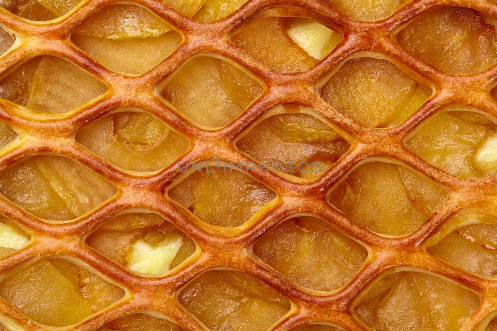 Macro shot of apple pie with tender custard layer and golden lattice crust, showcasing textures and warm tones of popular baked fruit dessert