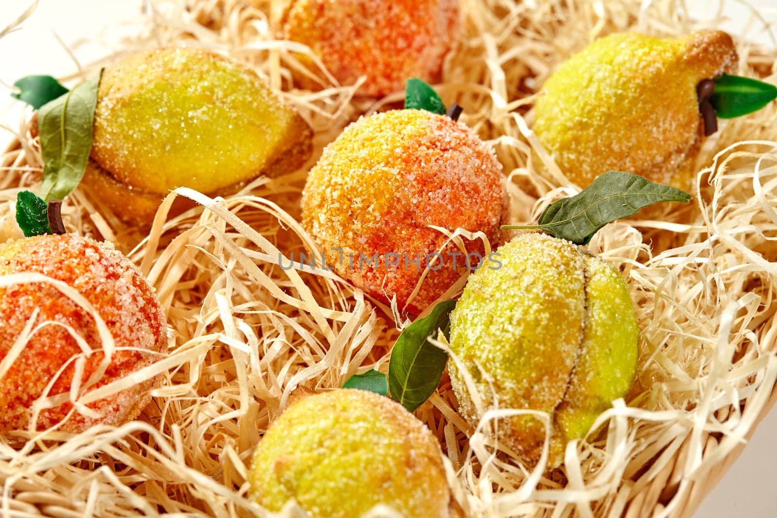 Assorted fruit-shaped shortcrust pastries in straw basket by nazarovsergey
