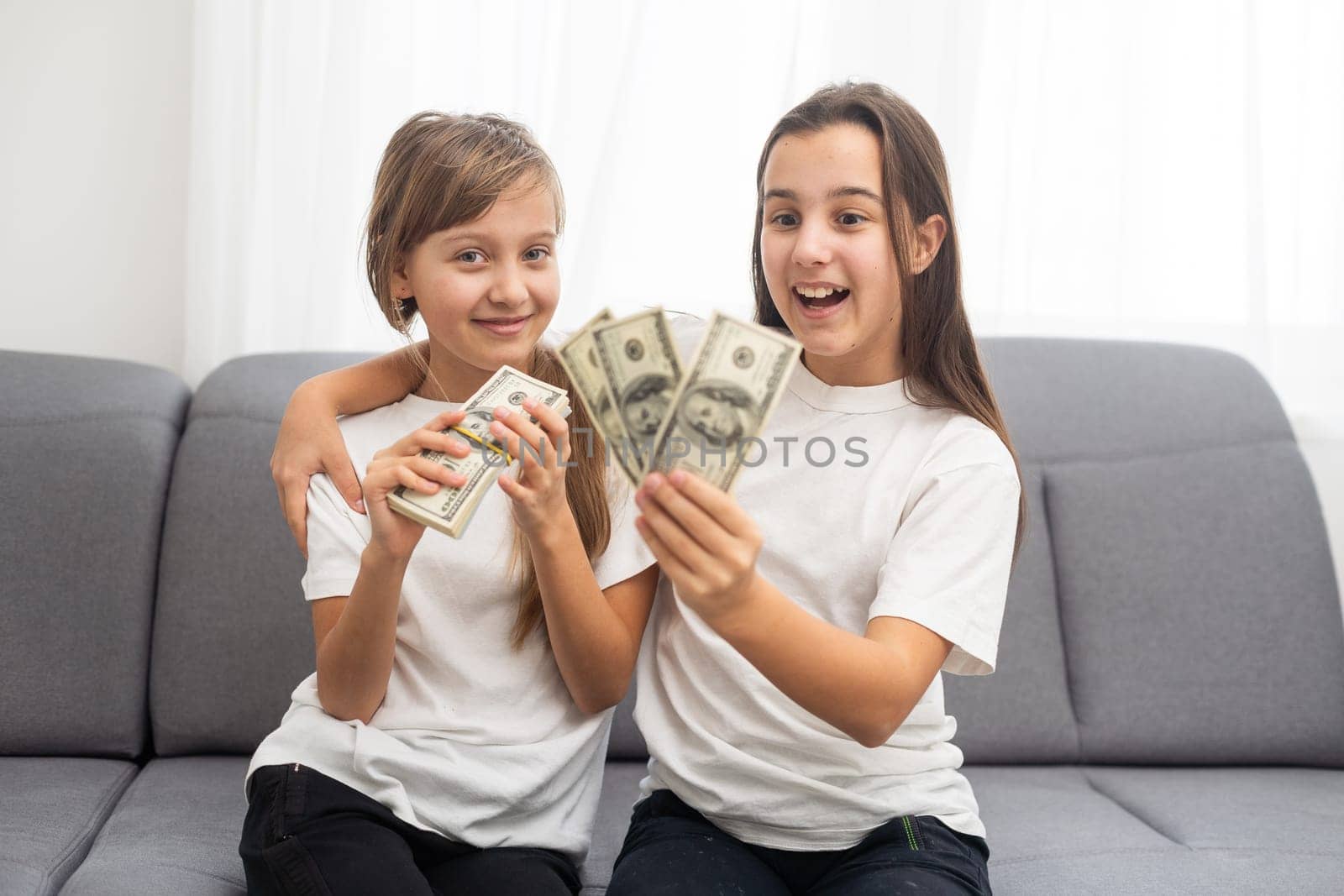 Photo of lucky caucasian girls wearing casual clothing holding fans of dollars in hands by Andelov13