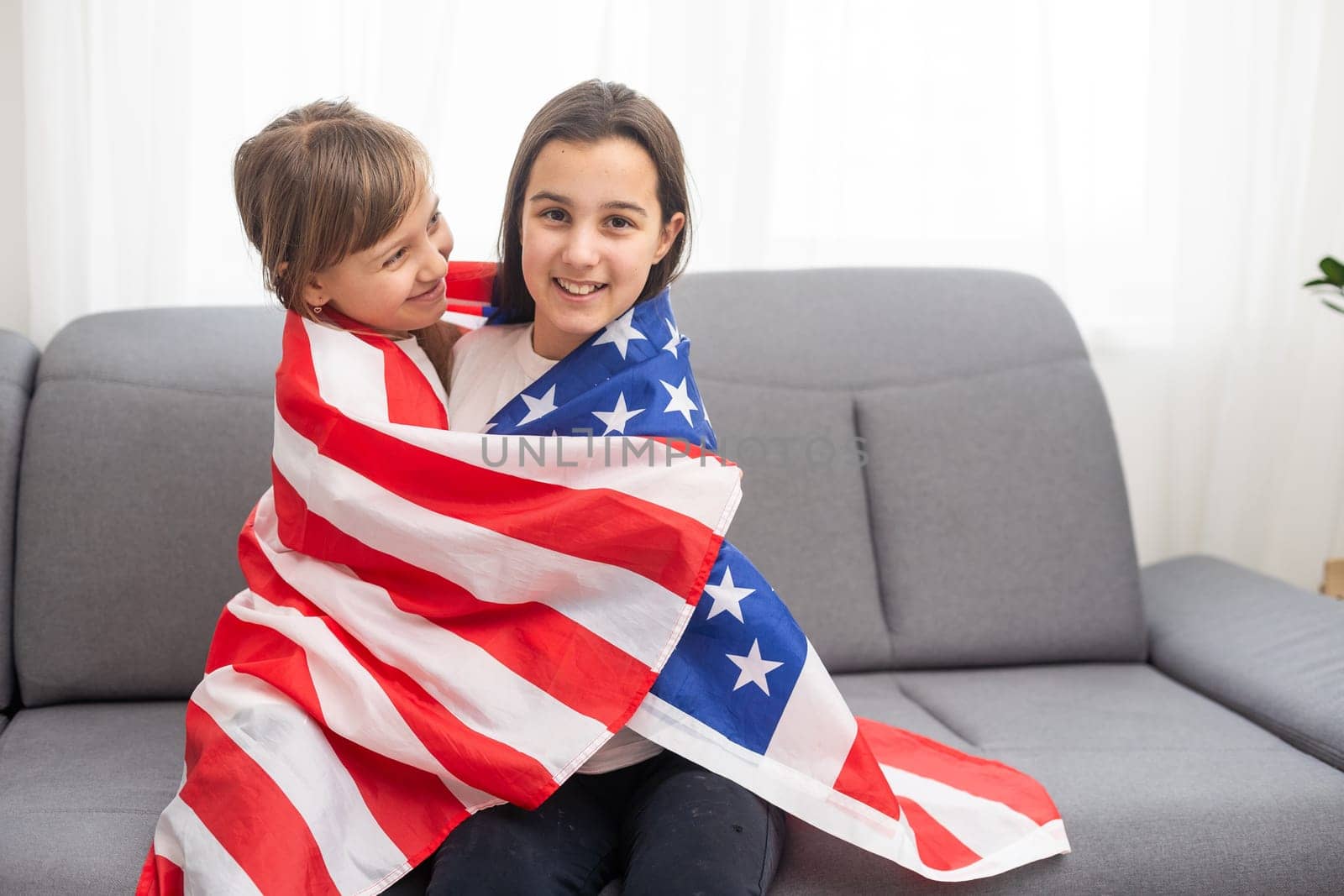 Two sisters with American flag on grey background by Andelov13