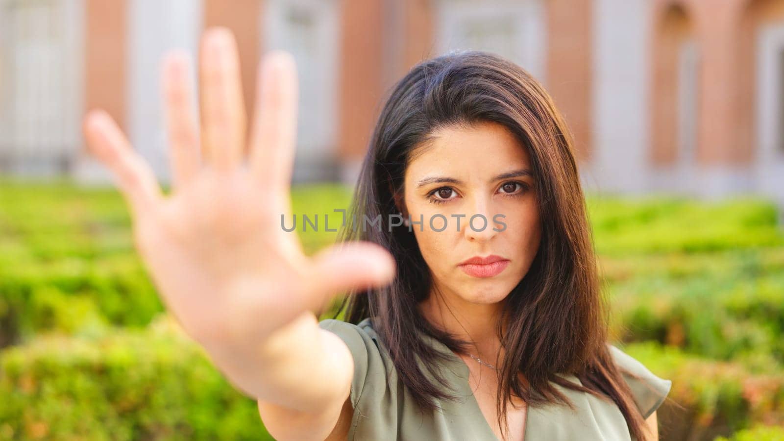 Woman gesturing stop with the hand with serious expression by ivanmoreno