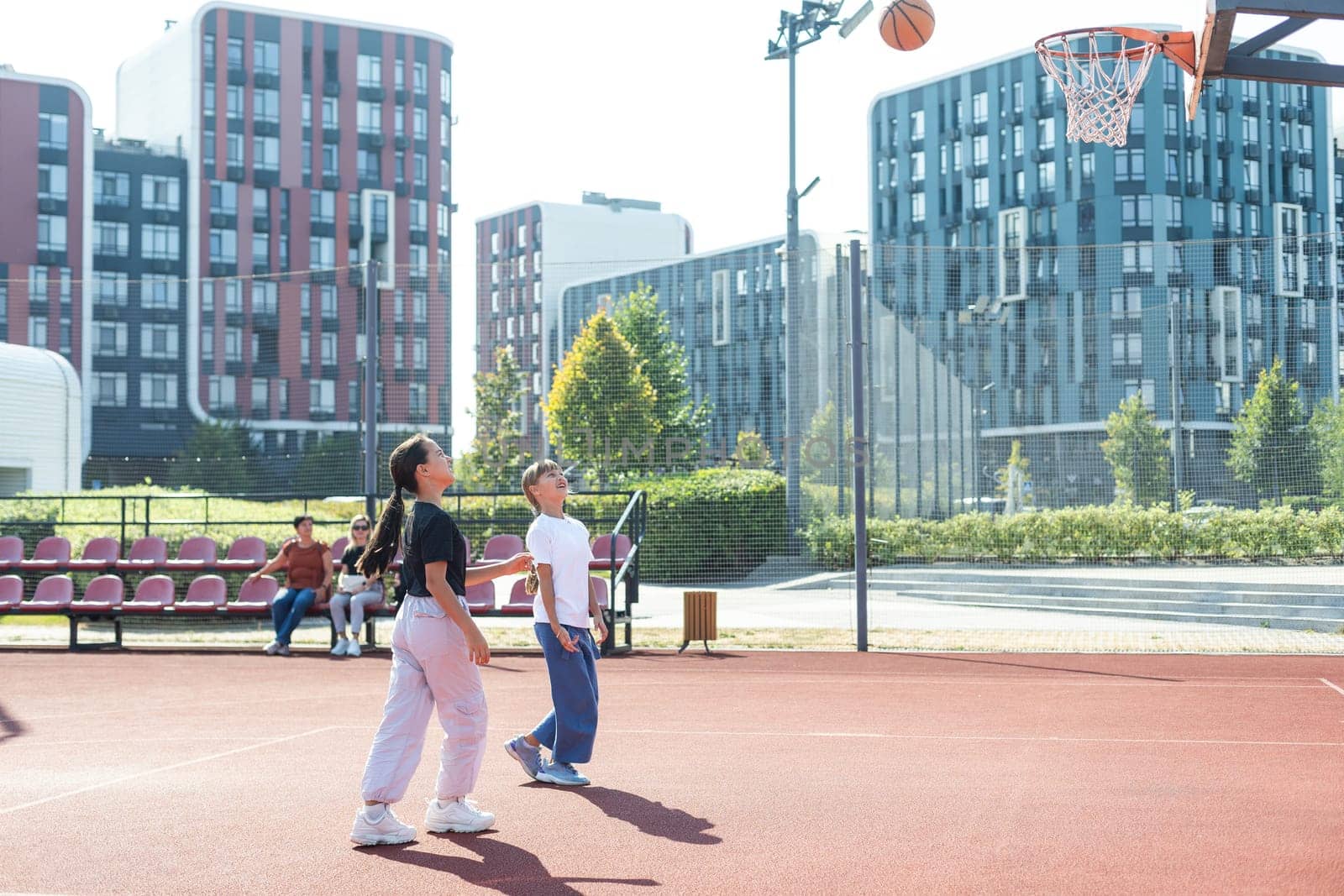 girls playing basketball on the basketball court by Andelov13