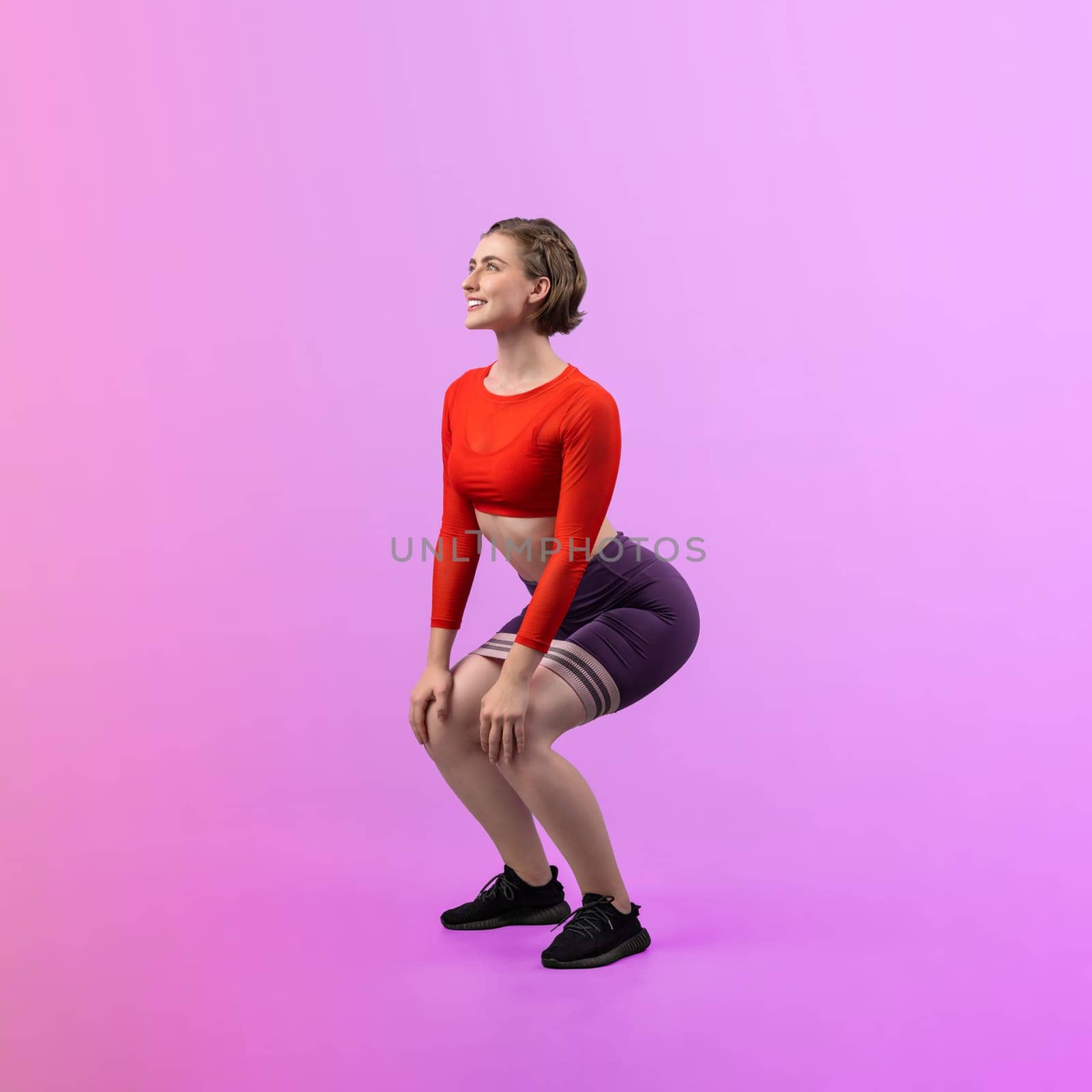 Full body length gaiety shot athletic sporty woman with kicking position posture by biancoblue