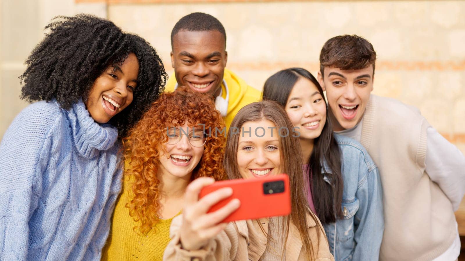 Group of diverse teenager people taking a selfie smiling and laughing outdoors