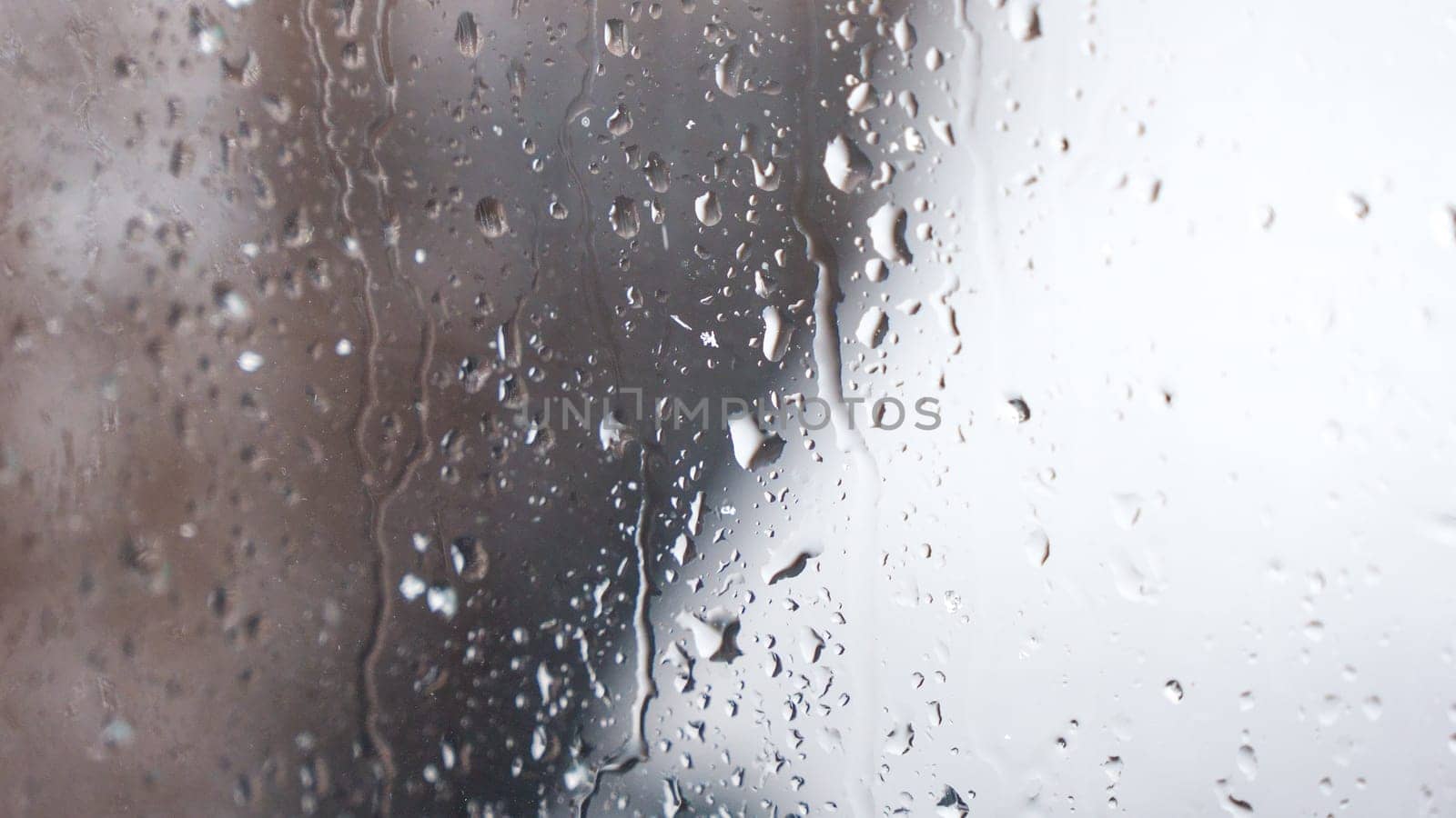 Macro of water drops on glass. Large rain drops strike window during winter shower. Pure rain drops. by JuliaDorian