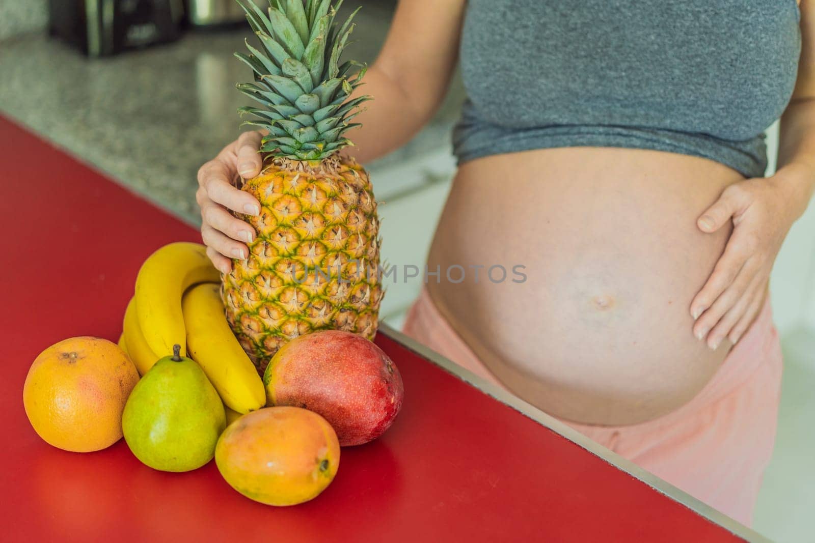 Embracing a healthy choice, a pregnant woman prepares to enjoy a nutritious moment, gearing up to eat fresh fruit and nourish herself during her pregnancy.