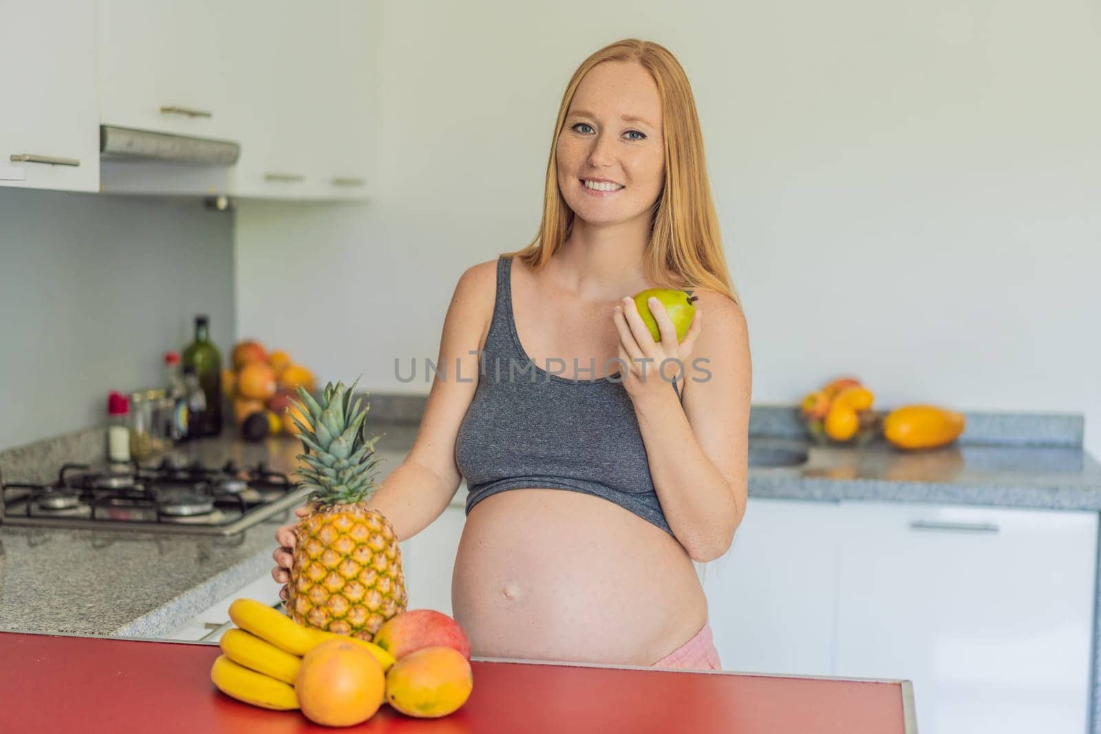 Embracing a healthy choice, a pregnant woman prepares to enjoy a nutritious moment, gearing up to eat fresh fruit and nourish herself during her pregnancy by galitskaya