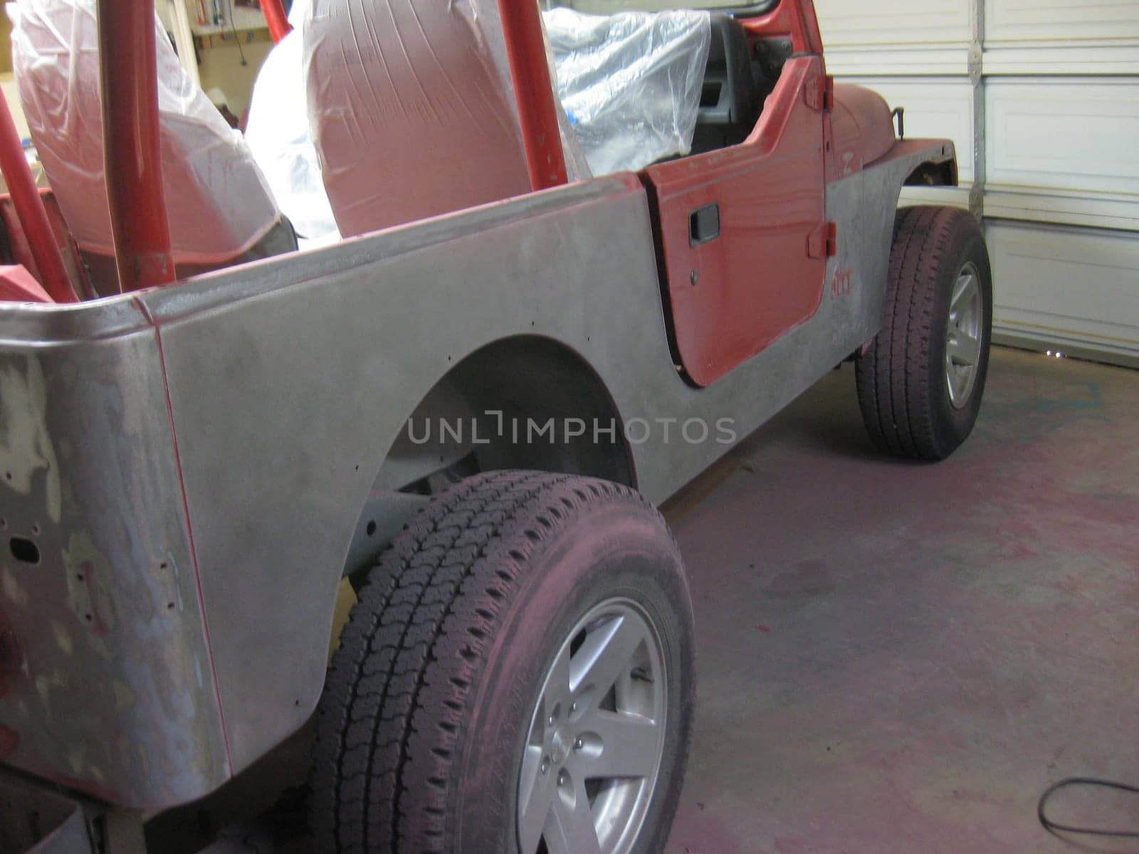 Auto Body Repair and Repainting Prep Work on Red Vehicle. High quality photo