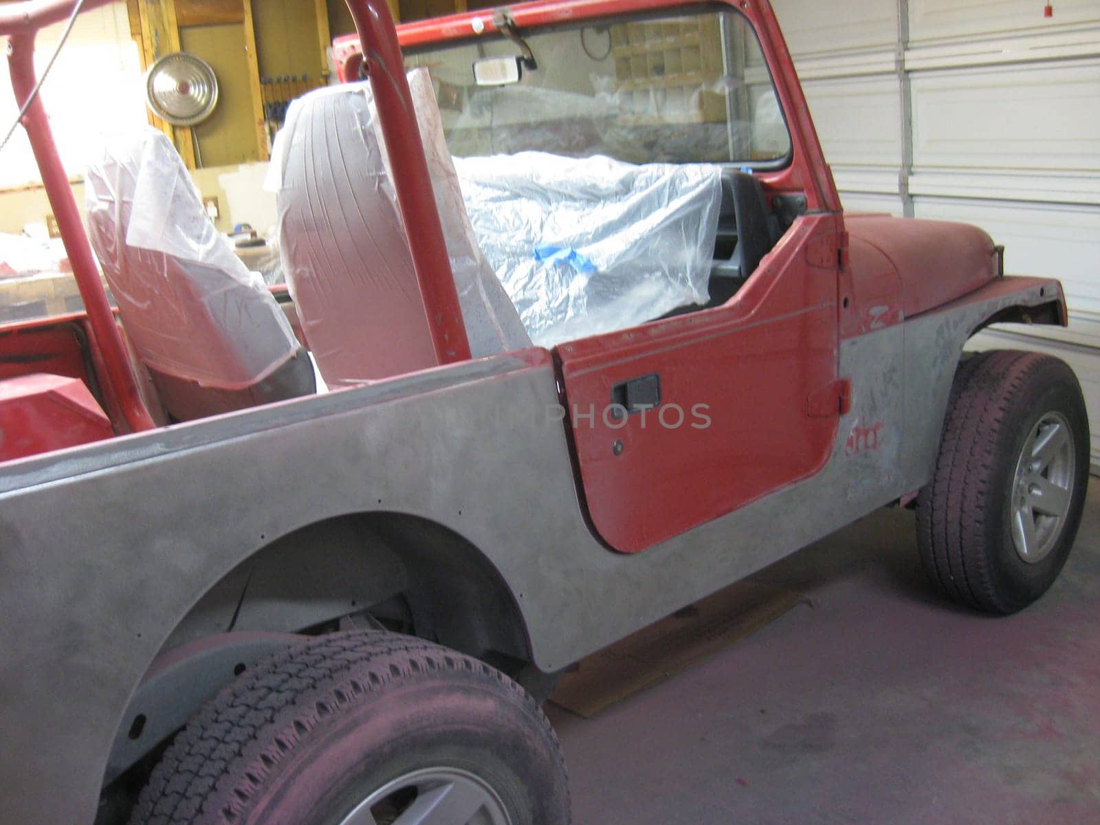 Auto Body Repair and Repainting Prep Work on Red Vehicle. High quality photo