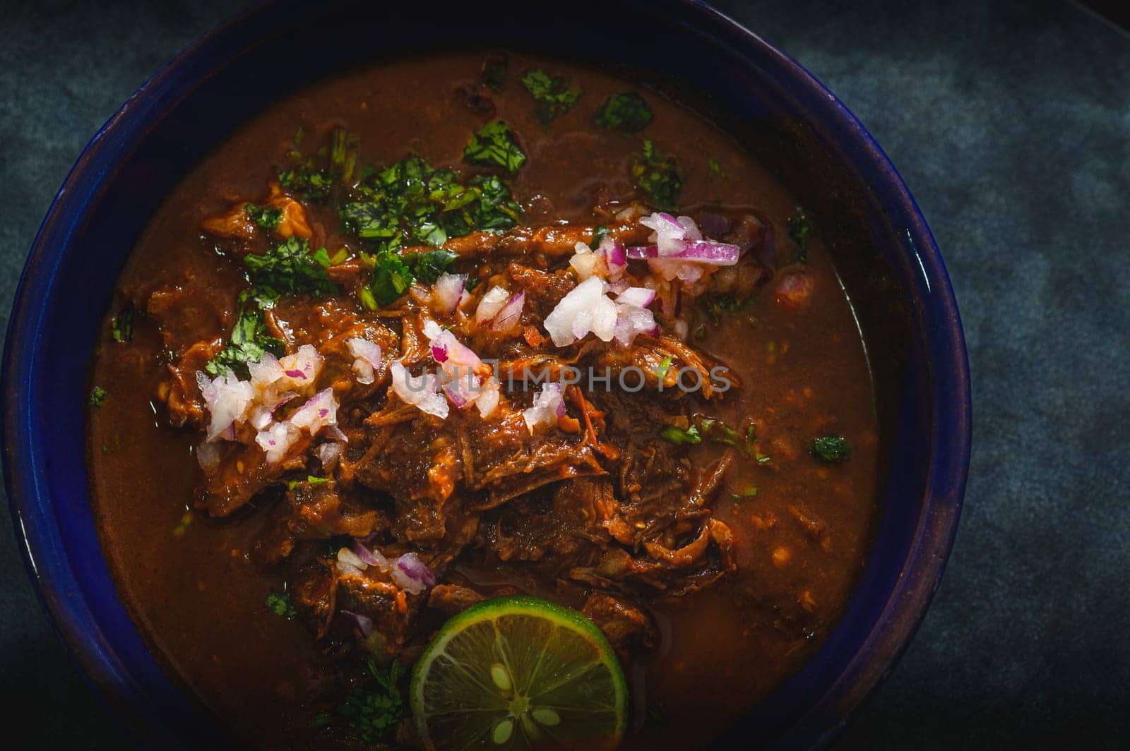 Bowl of Mexican Beef Birria Stew on Blue Background by RobertPB