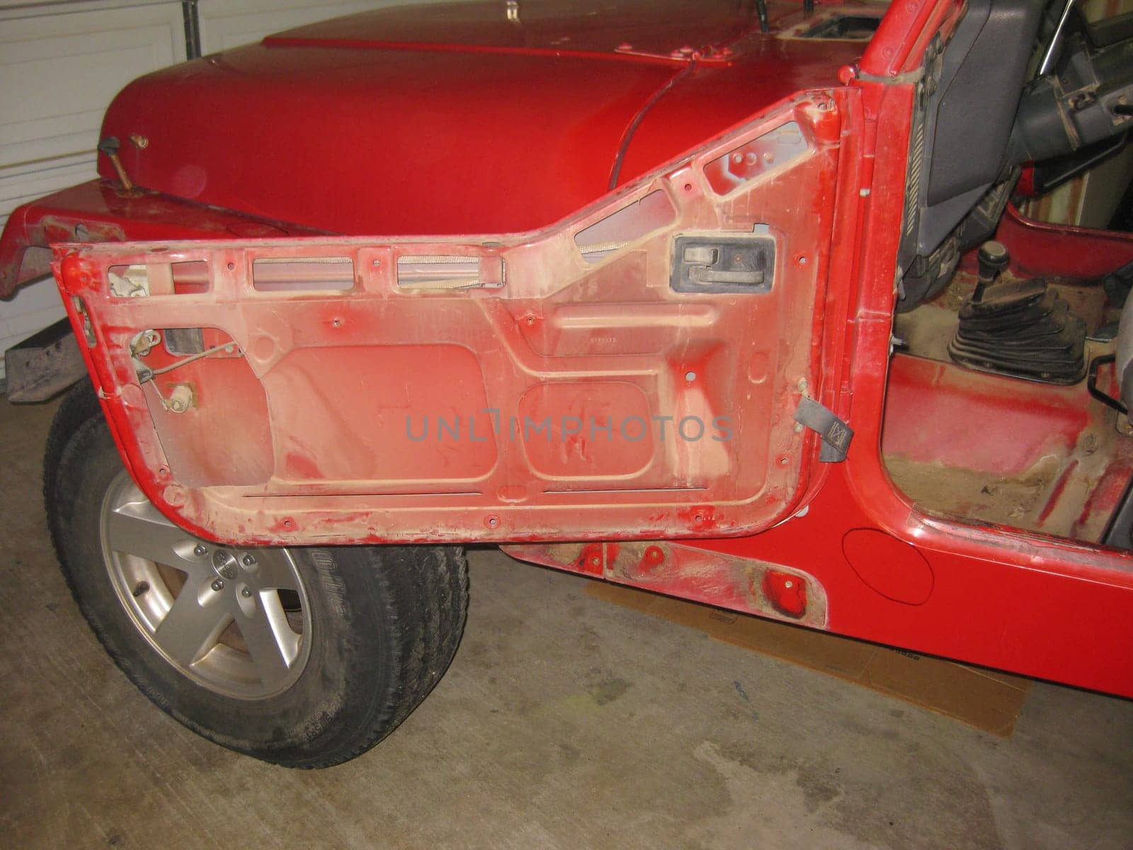 Auto Body Repair and Repainting Prep Work on Red Vehicle. High quality photo