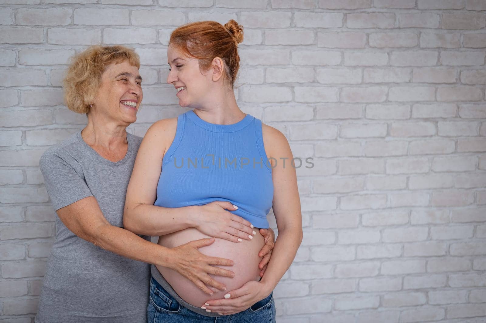 Elderly woman and her adult pregnant daughter. by mrwed54