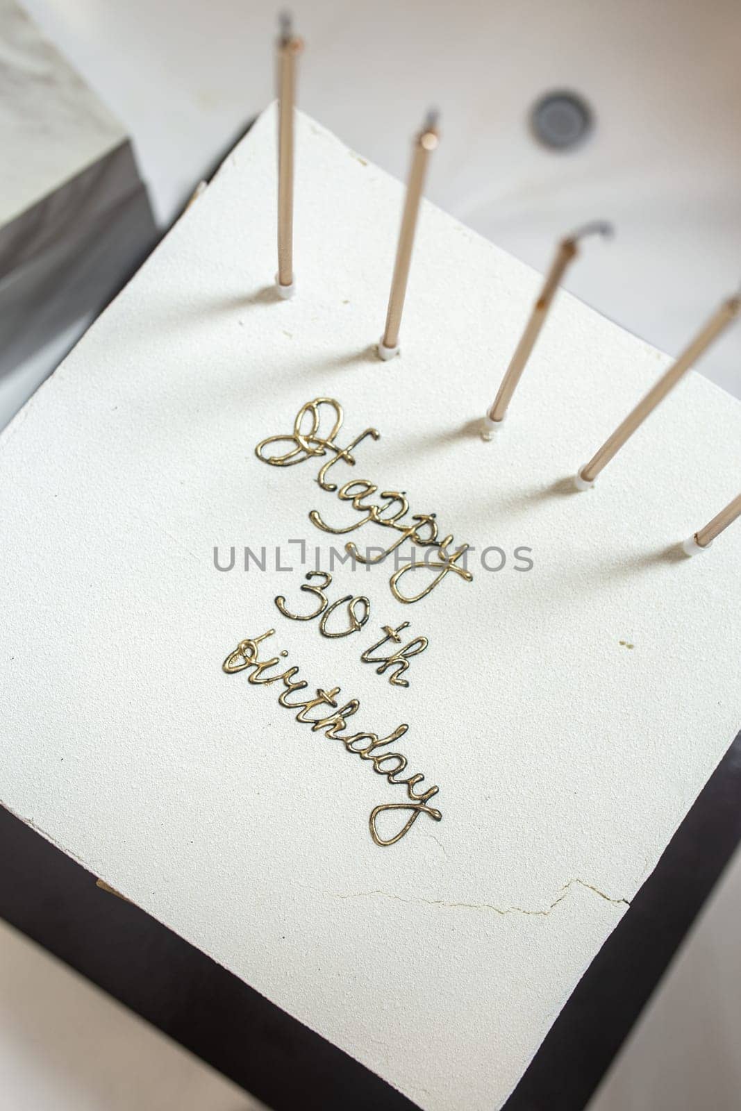 birthday greeting cake with candles top view. Youbiiley is 30 years old.