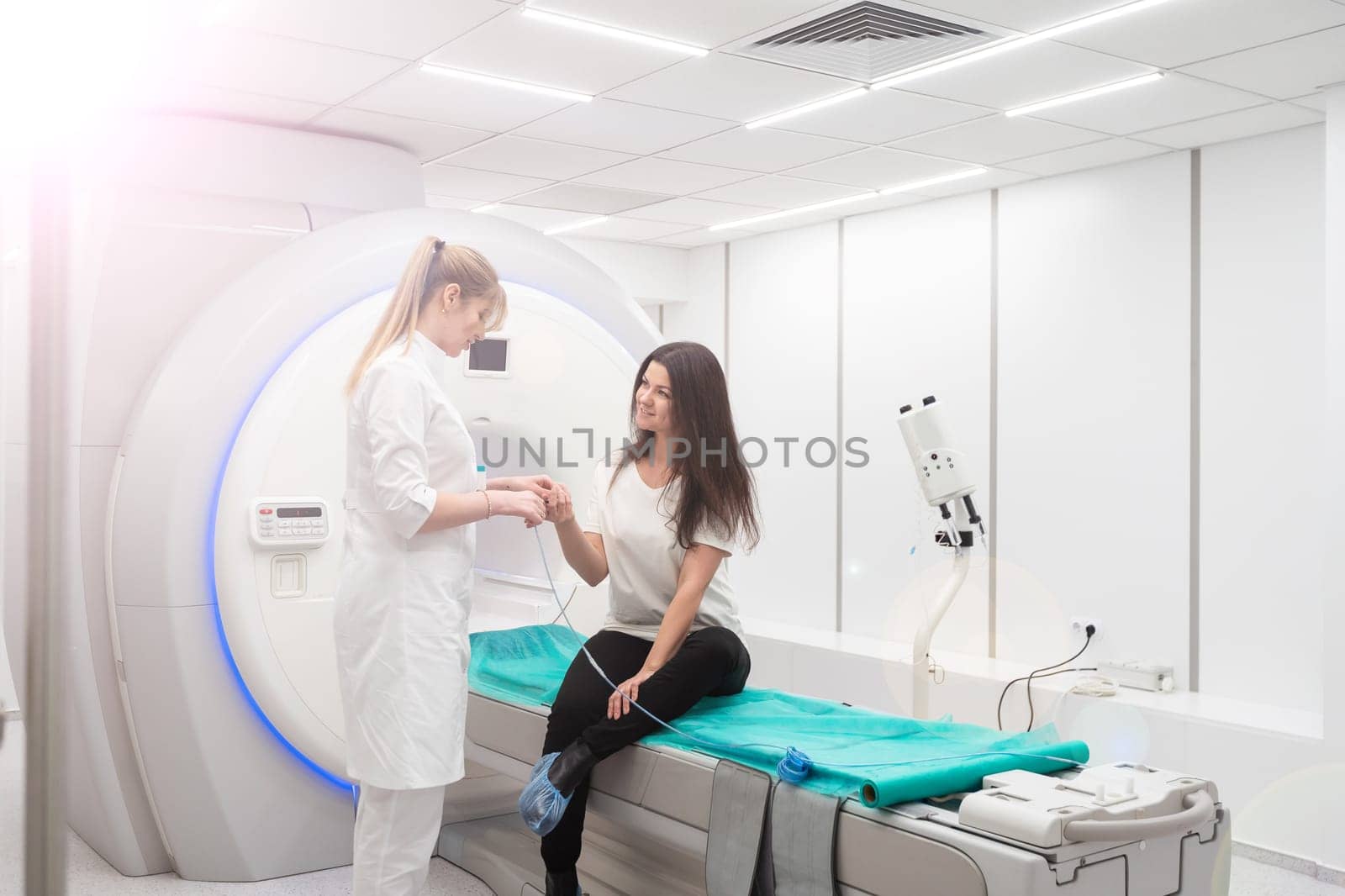 Female patient undergoing MRI - Magnetic resonance imaging in Hospital. Medical Equipment and Health Care.