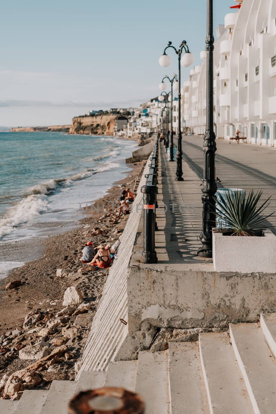 Coastal residential areas with a modern hotel and restaurant complex alongside sandy beaches. Summer holiday vacation and travel concept. by panophotograph