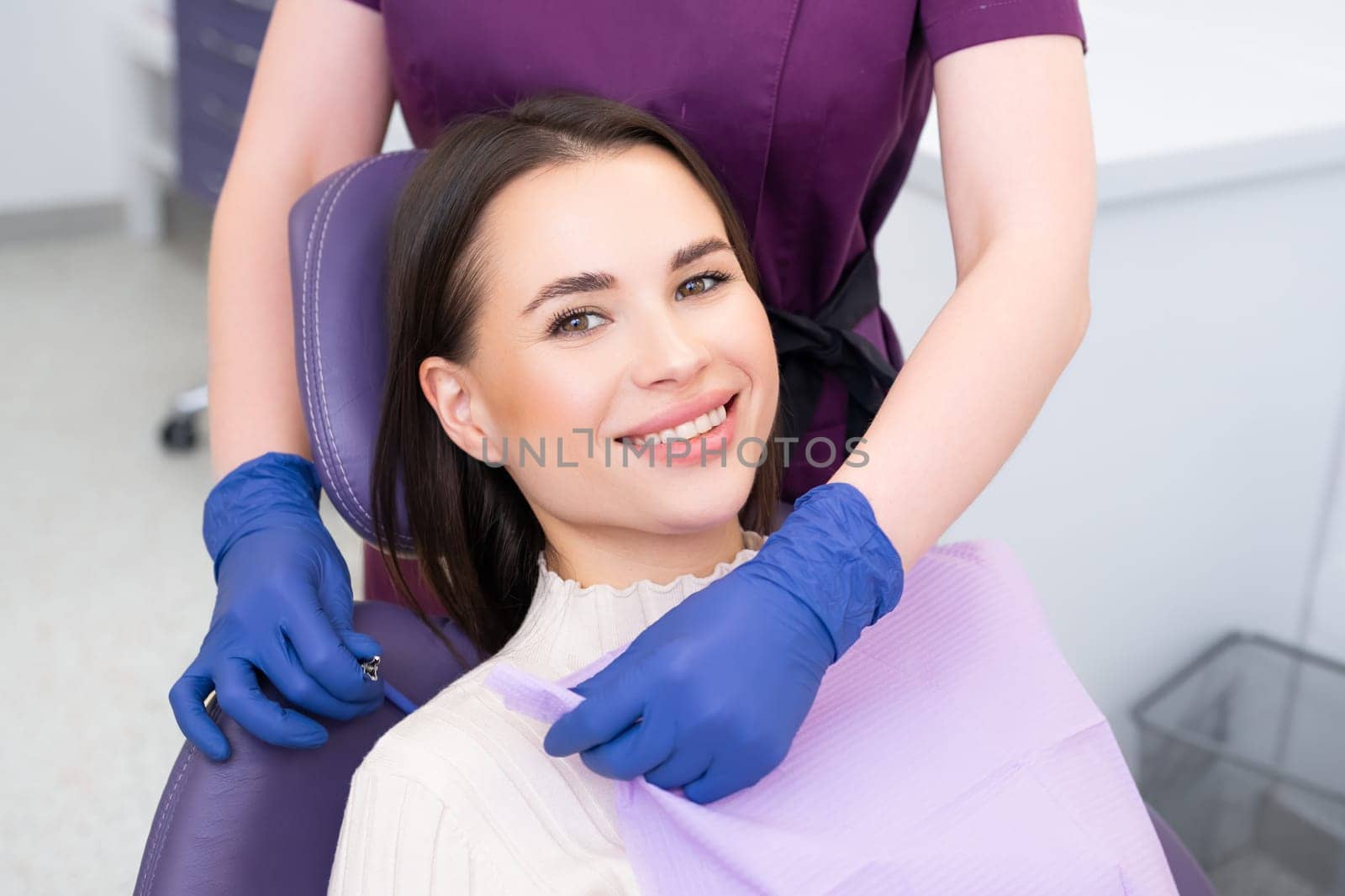 Beautiful brunette woman having dental treatment at dentists office