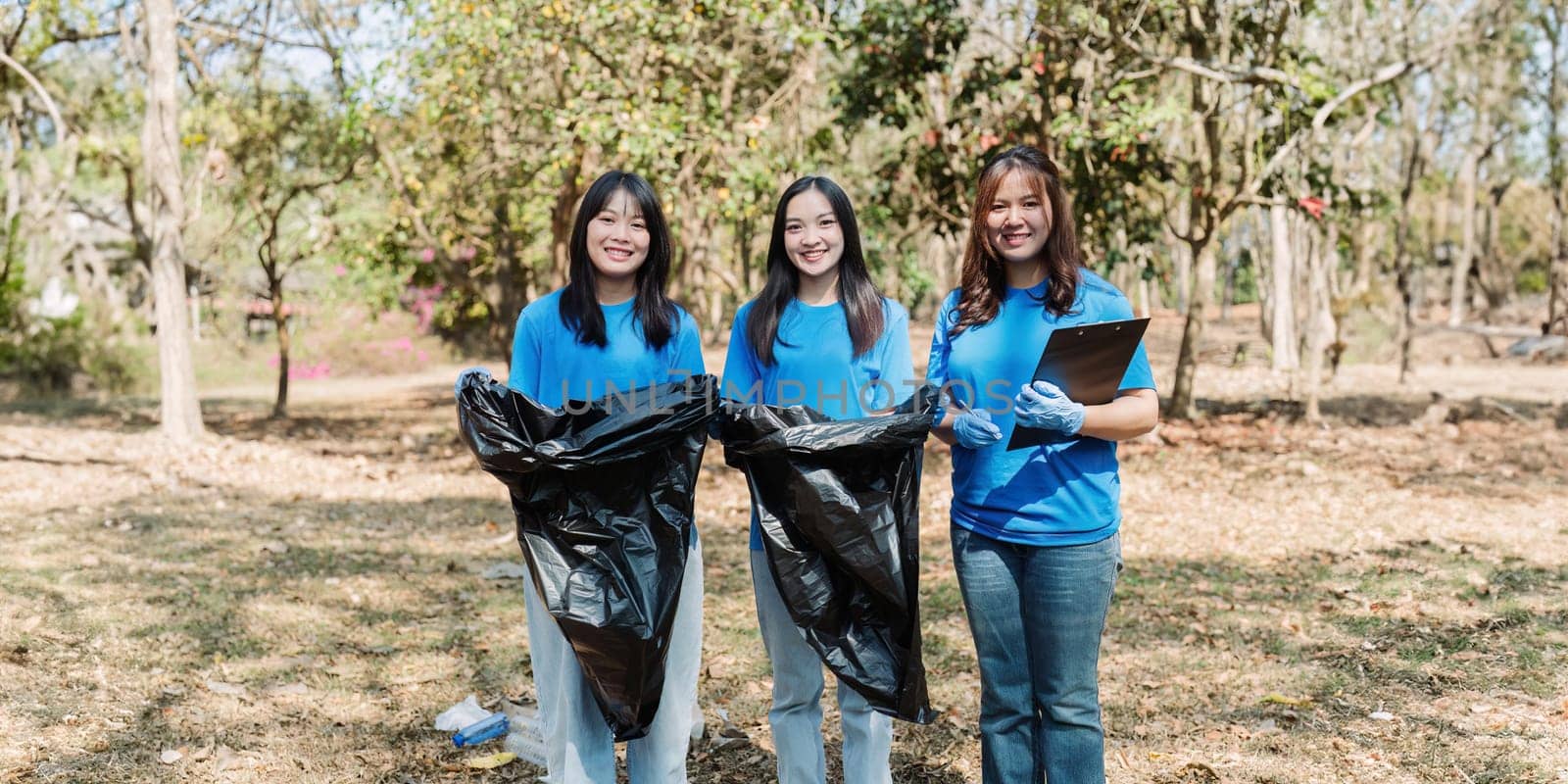 Group of volunteers, community members cleaning the nature from garbage and plastic waste to send it for recycling by itchaznong