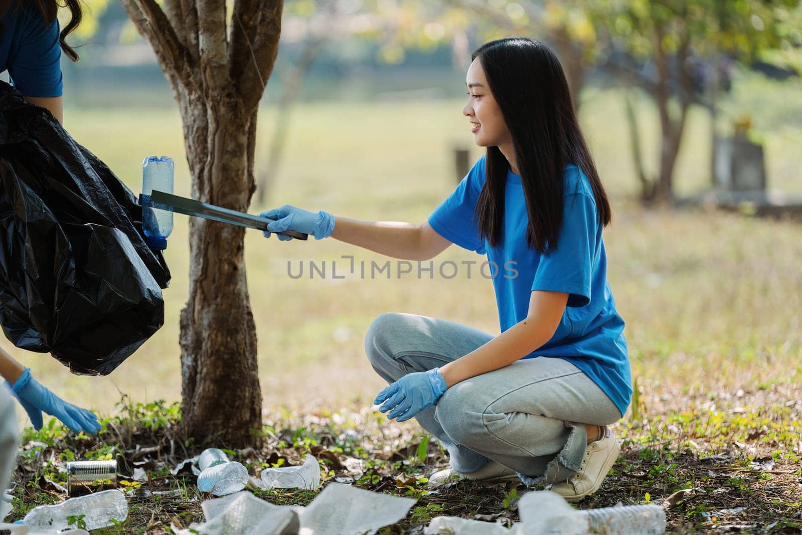 Group of volunteers, community members cleaning the nature from garbage and plastic waste to send it for recycling by itchaznong