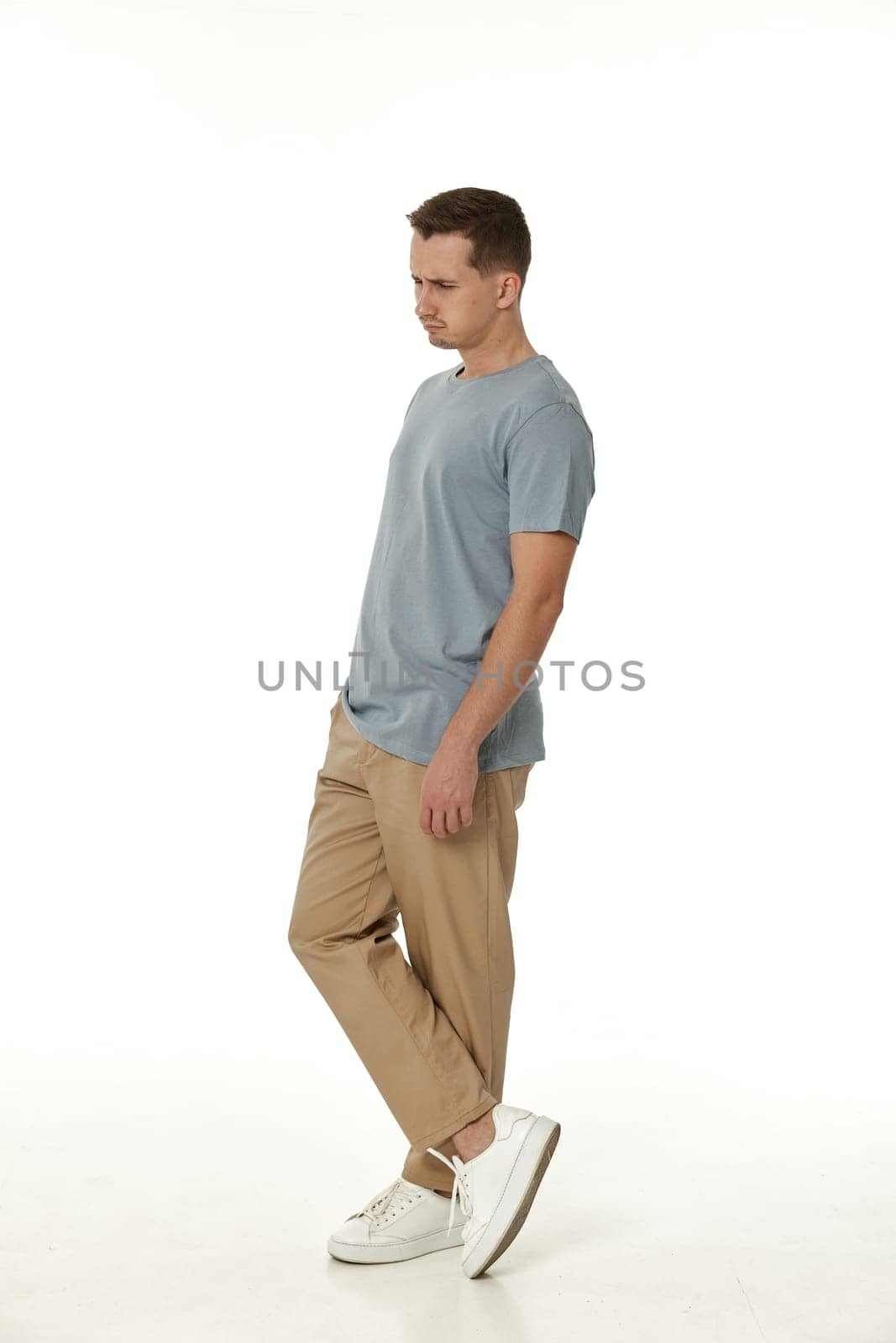offended frustrated young man on white background. sadness