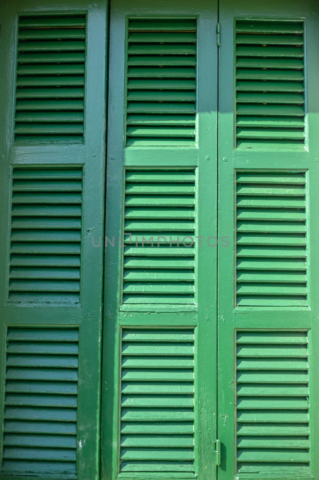 old green shutters in a house in the village