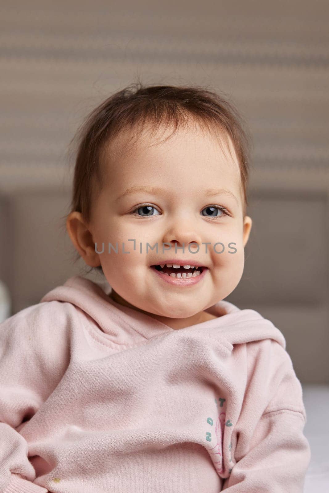 Cute little baby girl smiling in pink shirt by erstudio