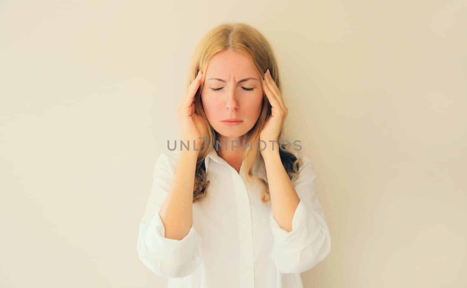 Exhausted tired woman employee with headache, suffers from migraine, tension in head at home by Rohappy