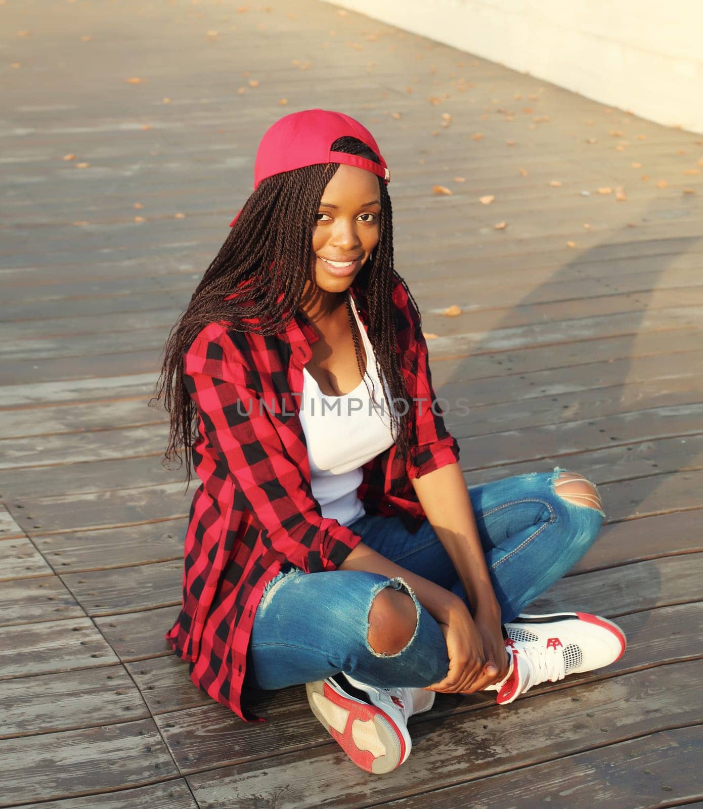 Portrait of stylish young african woman with dreadlocks posing wearing casual in the city by Rohappy