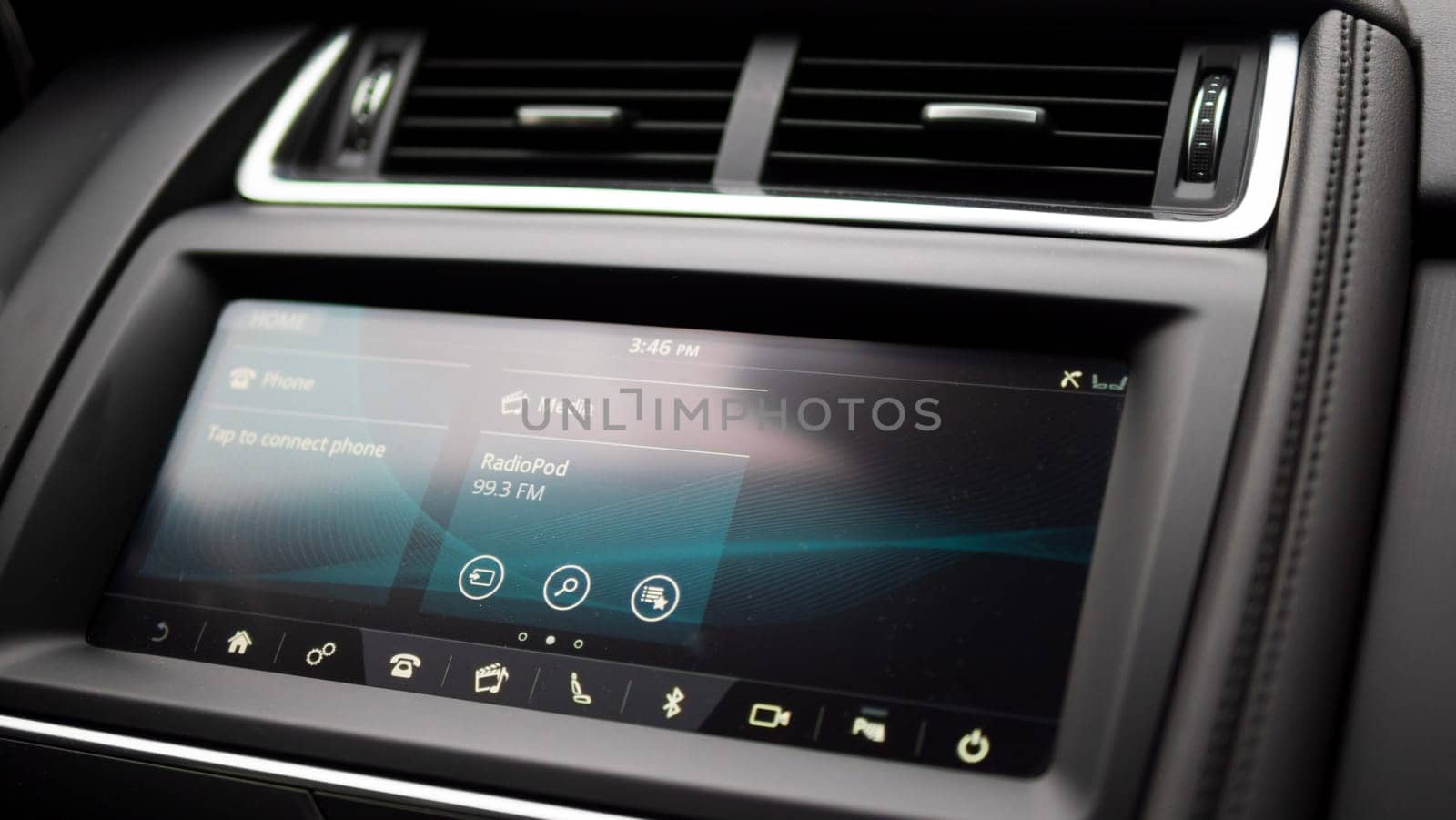 A closeup view of a car radio in a luxury vehicle showcasing automotive design and sophisticated audio equipment integrated into the cars dashboard