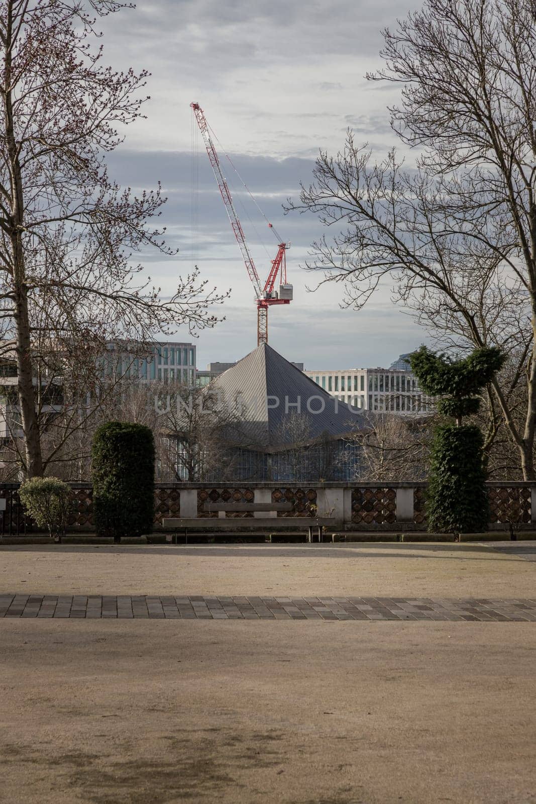 London, UK - Feb 15, 2024 - Construction work with crane and Hyperbolic-paraboloid roof of The design museum with sky background. Space for text, Selective focus.