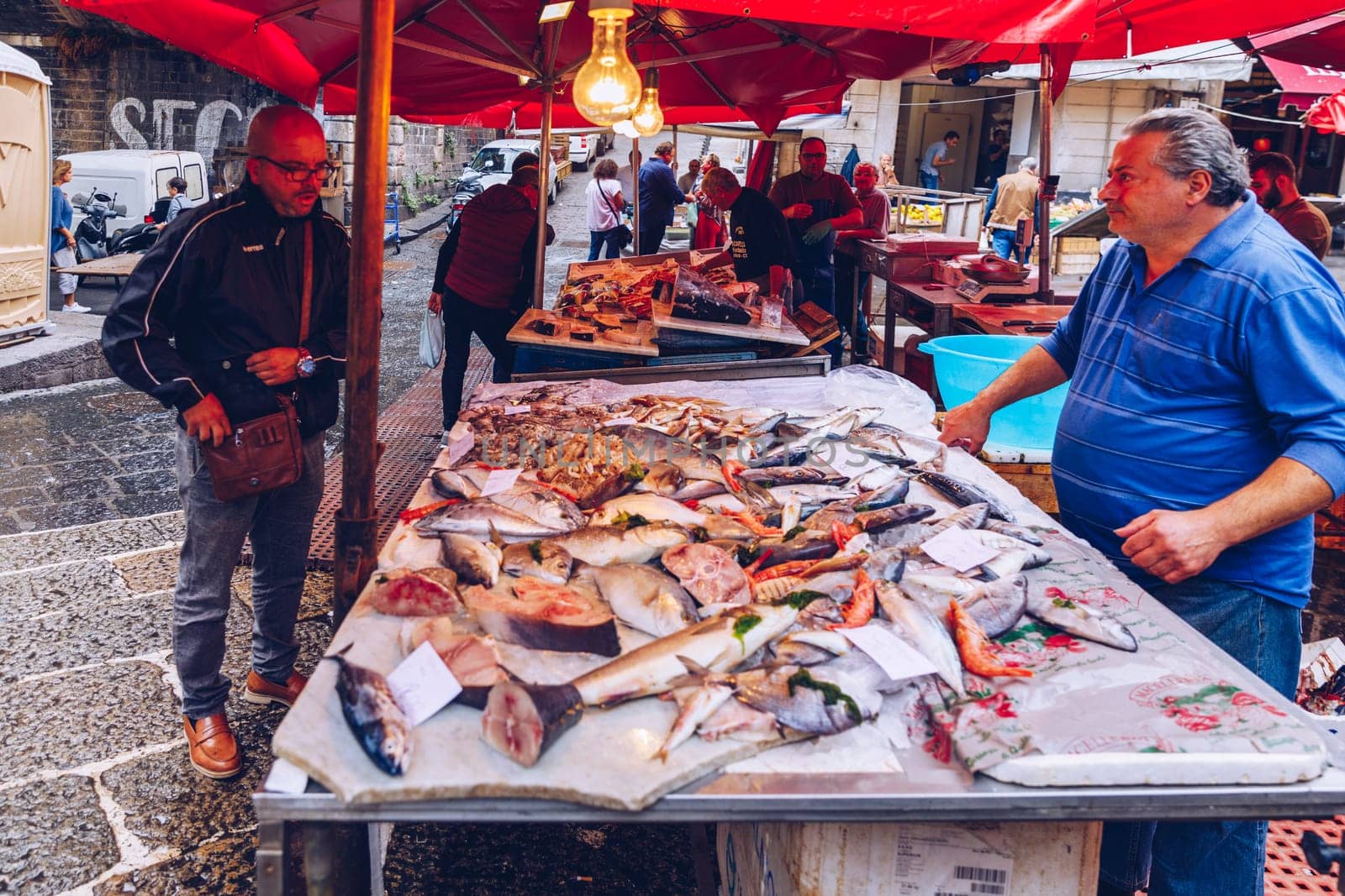 Catania, Italy - November 1, 2019: Seafood at fish market in Catania, Sicily, Italy. Fresh fish at the fish market in the old Town of Catania in the province of Sicily in Italy. 