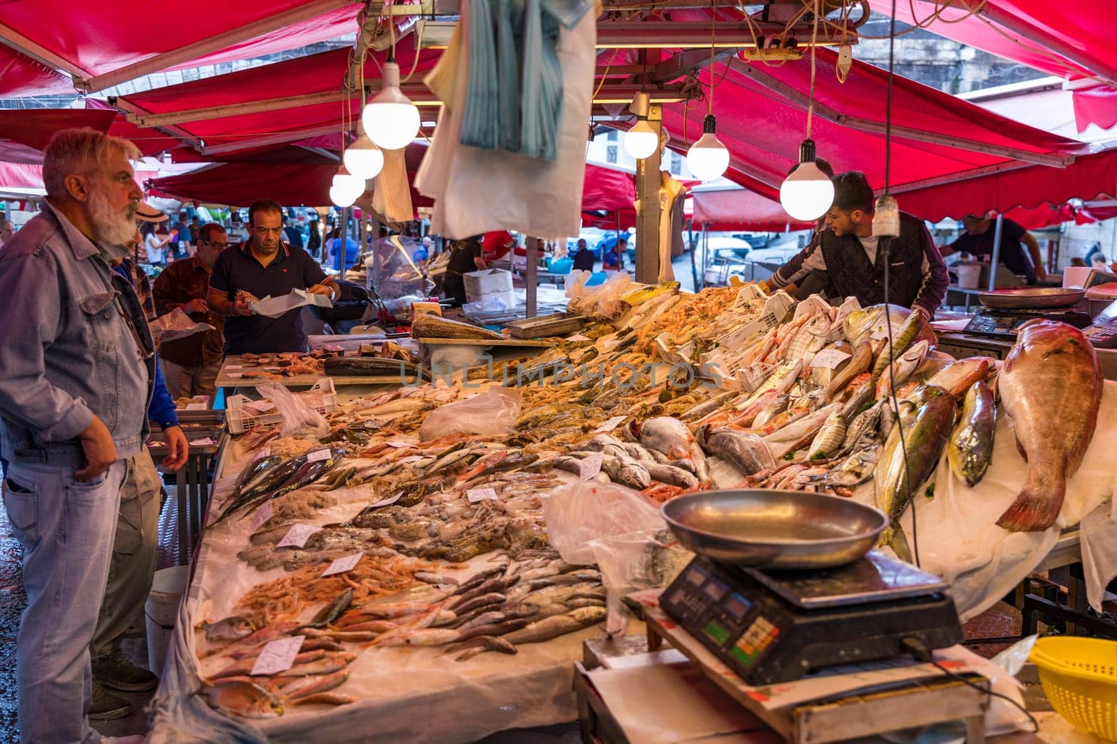Catania, Italy - November 1, 2019: Seafood at fish market in Catania, Sicily, Italy. Fresh fish at the fish market in the old Town of Catania in the province of Sicily in Italy. 