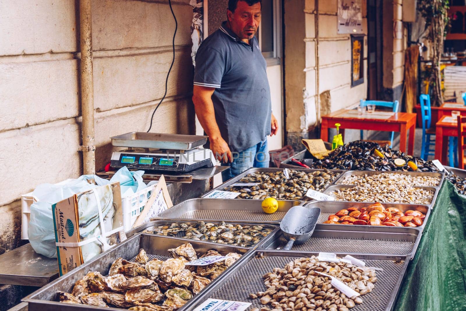 Catania, Italy - November 1, 2019: Seafood at fish market in Catania, Sicily, Italy. Fresh fish at the fish market in the old Town of Catania in the province of Sicily in Italy. 