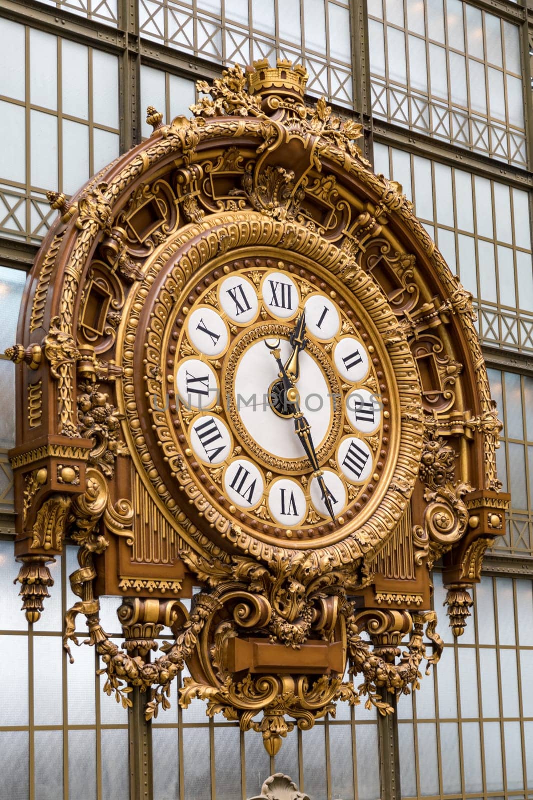 Paris, France - July 5, 2018: Golden clock of the museum D'Orsay. The Musee d'Orsay is a museum in Paris, on the left bank of the Seine. Golden colored clock inside Musee d'Orsay Museum in Paris.