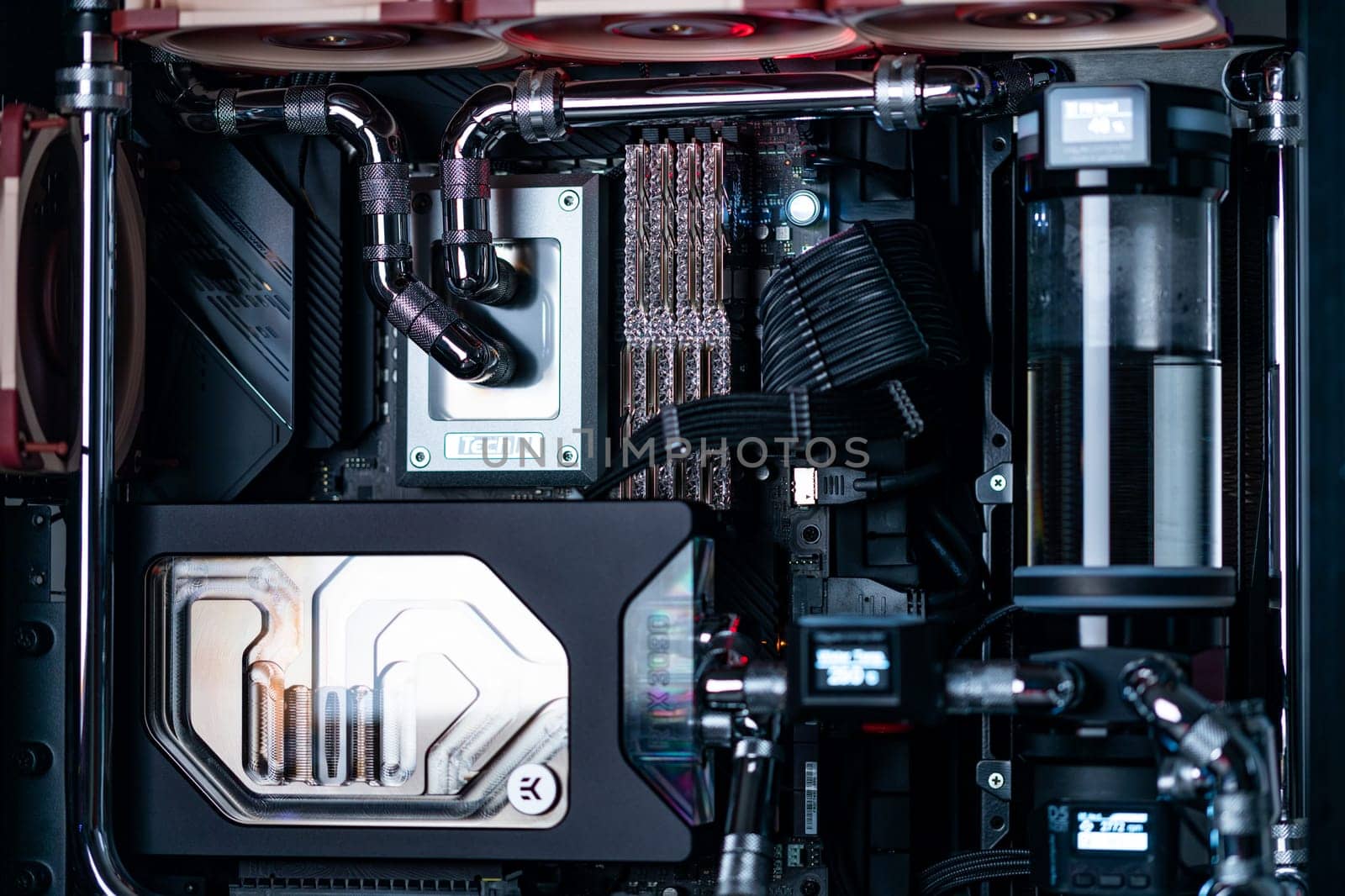 Prague, Czech Republic - 21 July 2021: Close-up of high performance Desktop PC and water cooling system with multicolored LED RGB light show status on working, interior on Computer PC Case and DIY