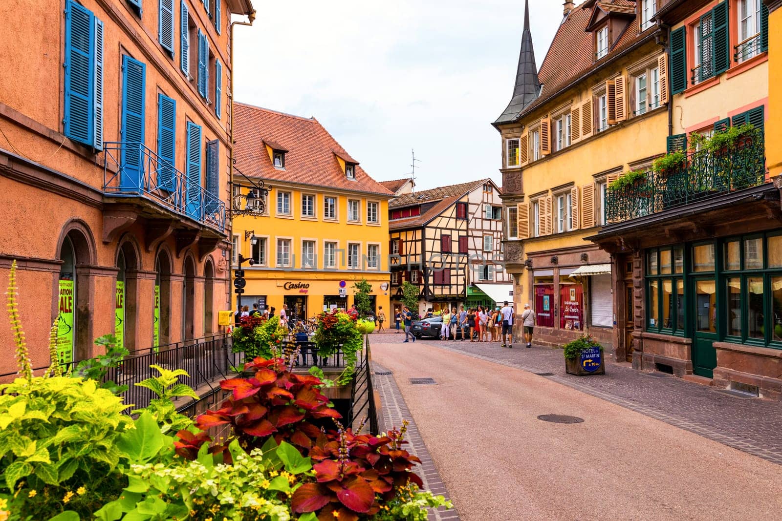 Colmar, France - July 27, 2018: Old town of Colmar, Alsace, France. View with colorful buildings, canal and flowers. Colmar, France. Petite Venice, water canal and traditional half timbered houses.