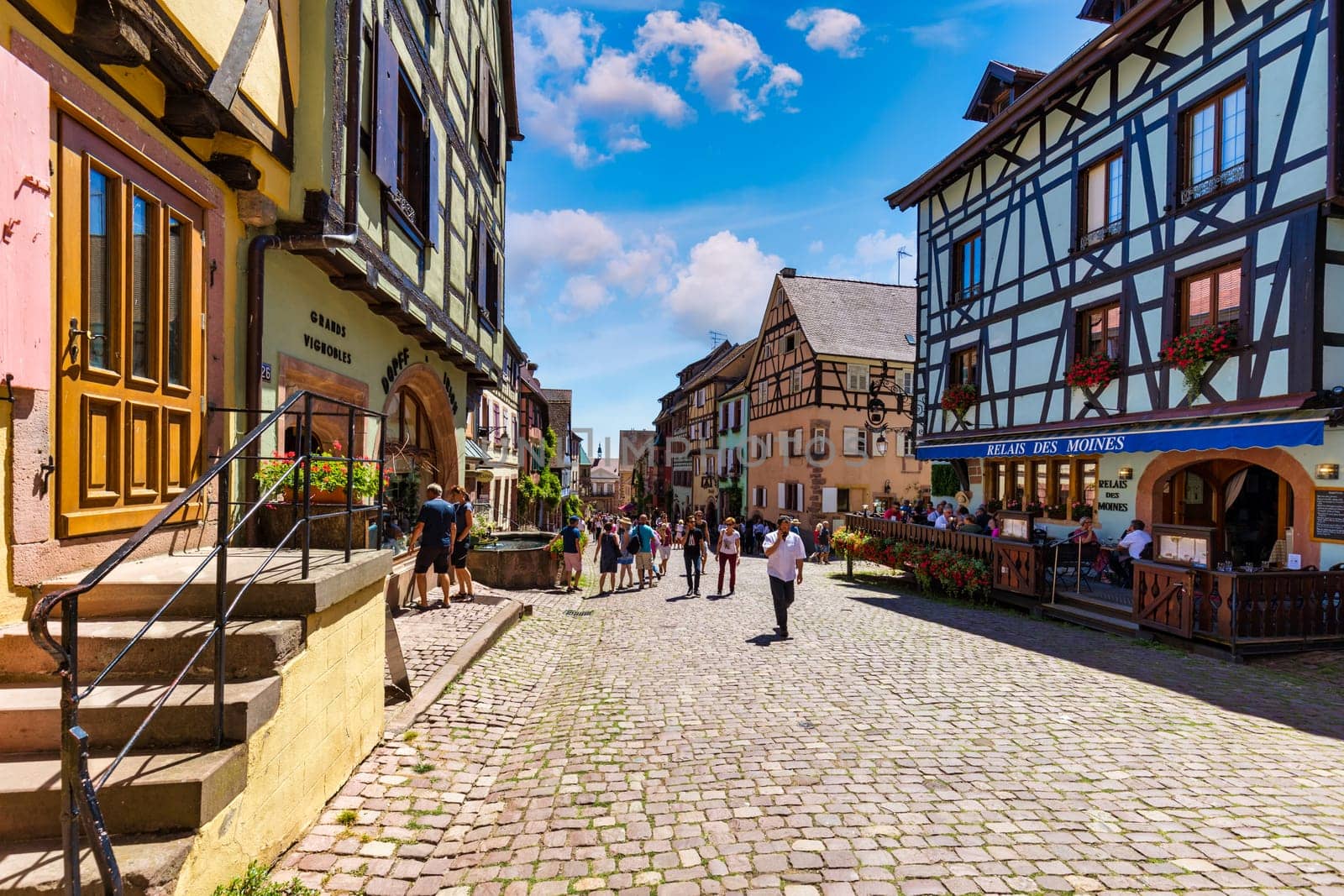 Riquewihr, France - July 2, 2022: Riquewihr village on Alsatian Wine Route, France. Most beautiful villages of France, Riquewihr in Alsace, famous "vine rote". Colorful town of Riquewihr, France.