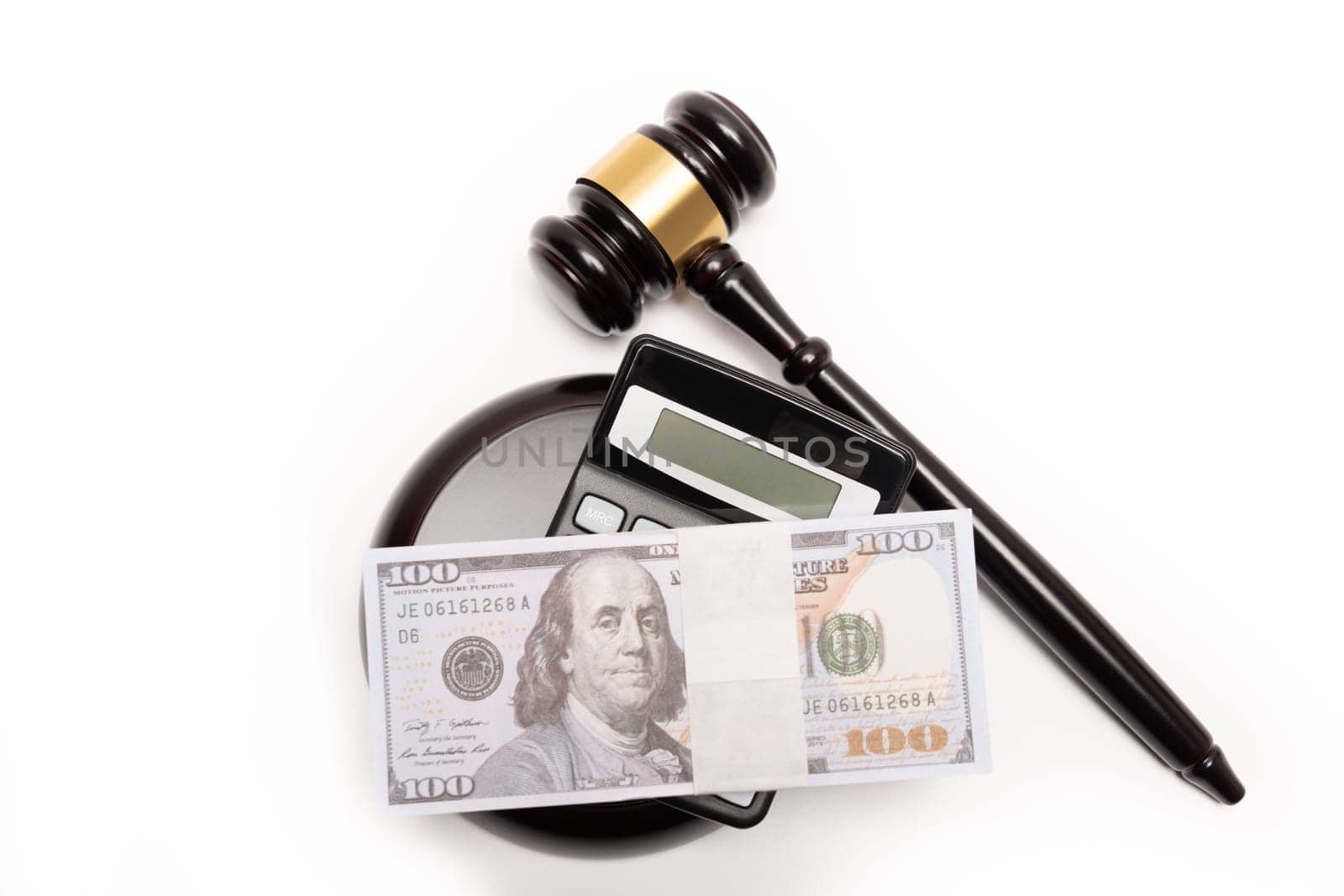 An isolated image of a judge's gavel on a stack of cash with a calculator, signifying legal fines or bail. by jbruiz78