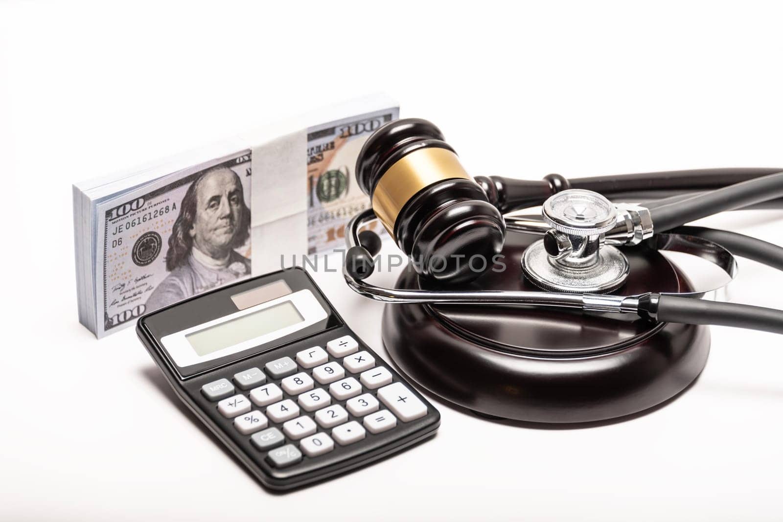 A conceptual image featuring a gavel, cash, and stethoscope symbolizing medical malpractice litigation. by jbruiz78