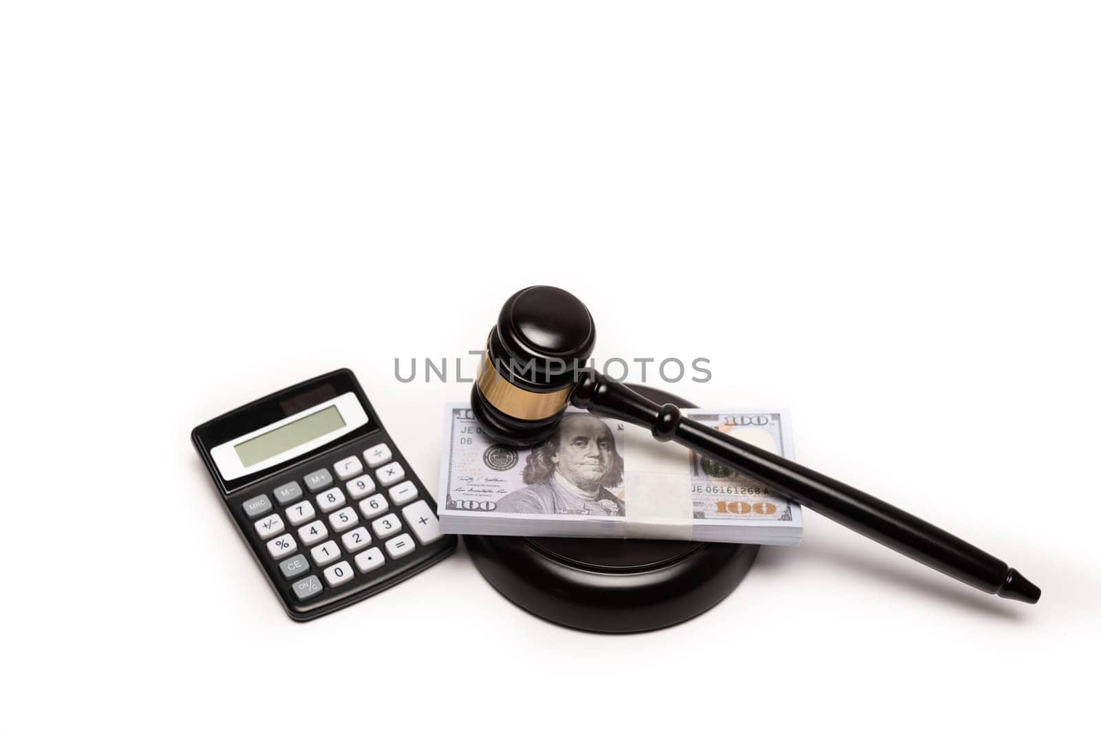 An isolated image of a judge's gavel on a stack of cash with a calculator, signifying legal fines or bail. by jbruiz78