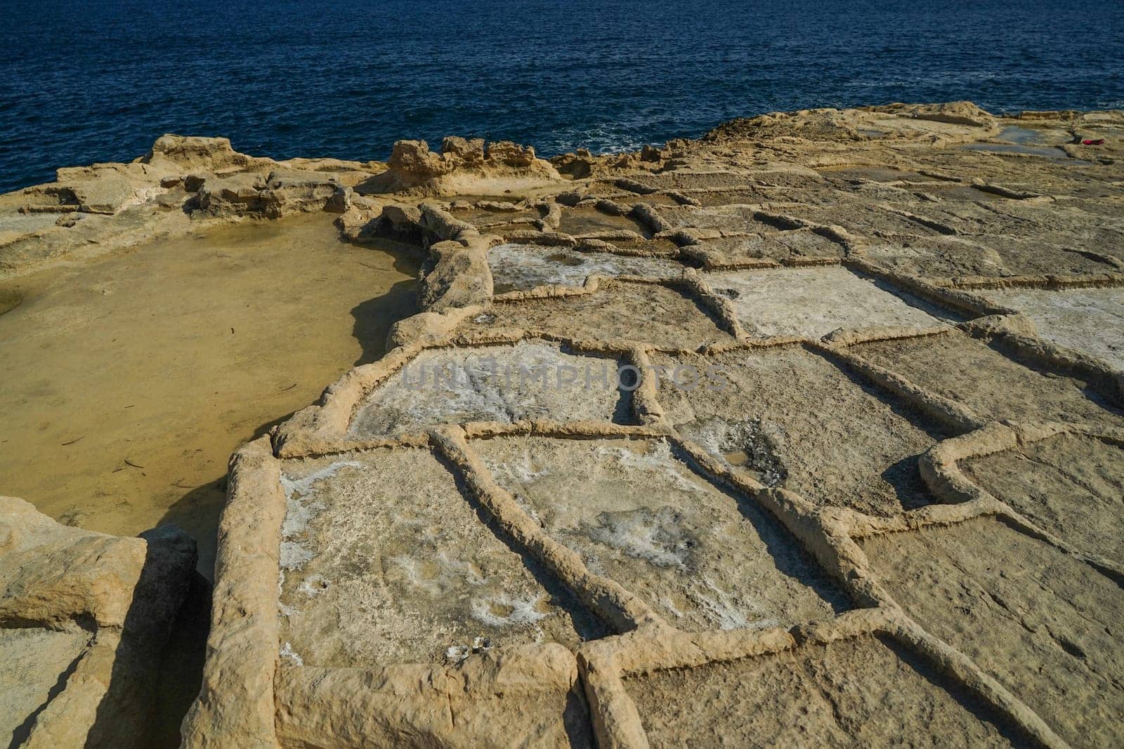 saint peter pools Malta rock formation hole on rocks by AndreaIzzotti