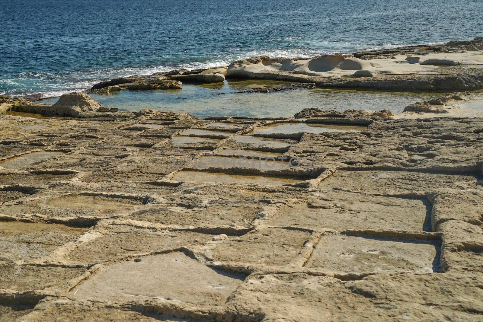 saint peter pools Malta rock formation hole on rocks by AndreaIzzotti