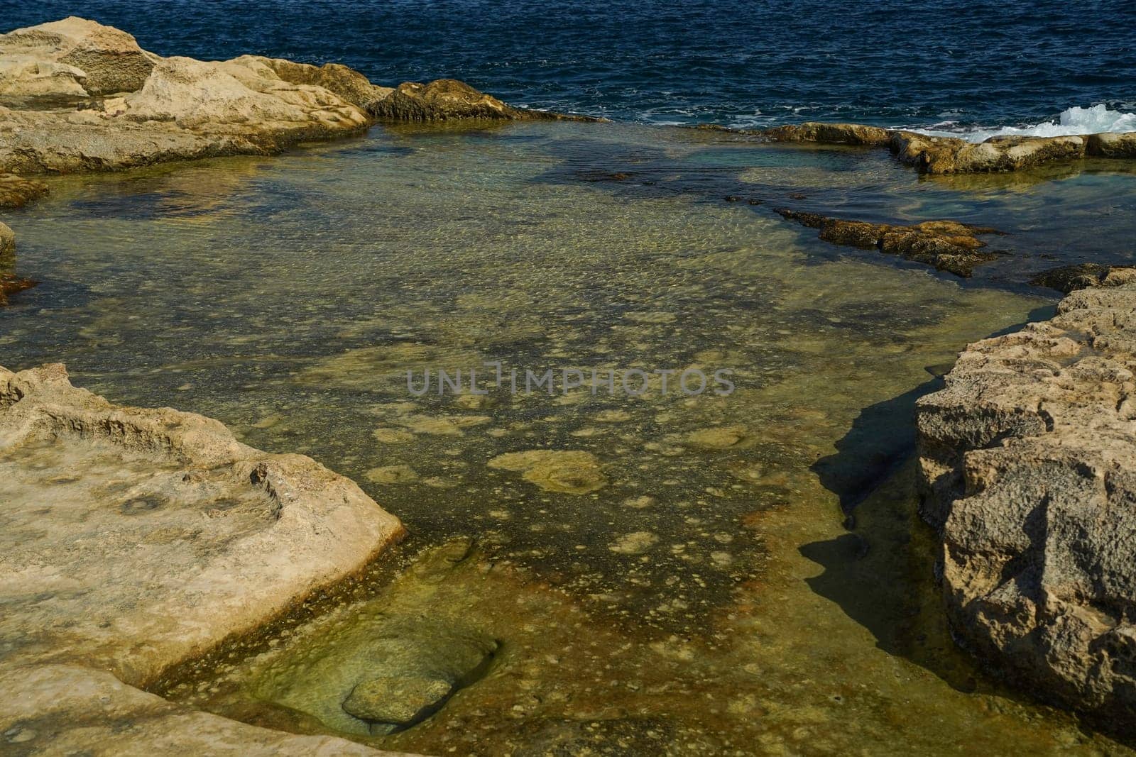 saint peter pools Malta rock formation hole on rocks by AndreaIzzotti