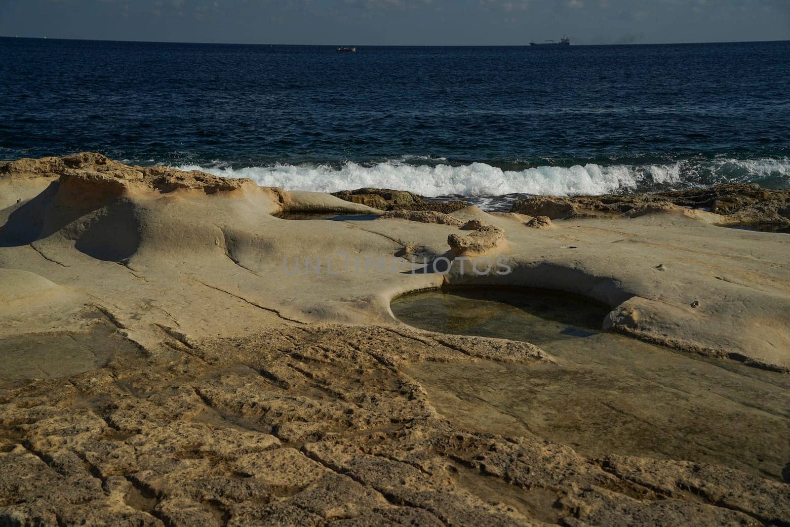 saint peter pools Malta rock formation hole on rocks by AndreaIzzotti