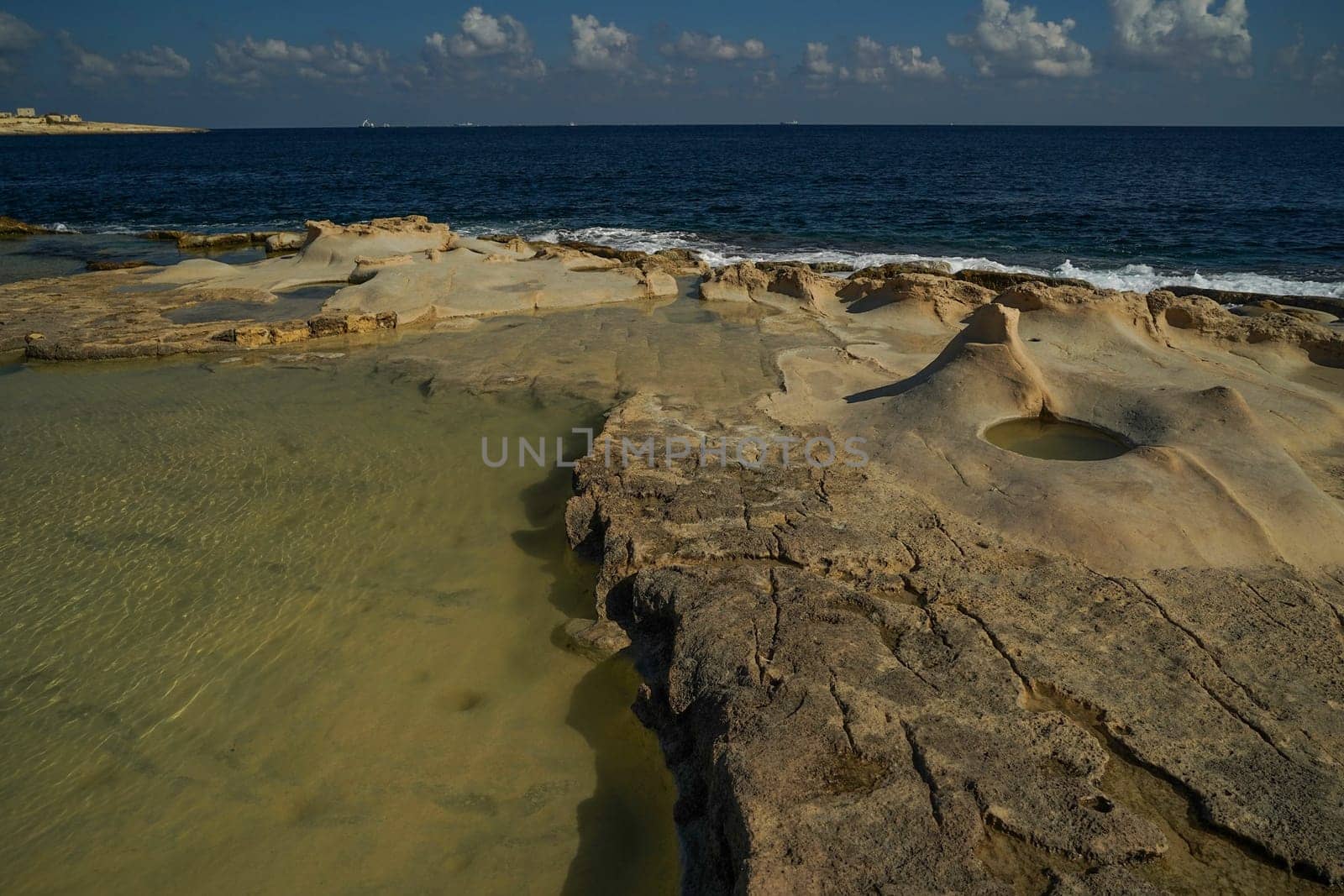 saint peter pools Malta rock formation hole on rocks by AndreaIzzotti