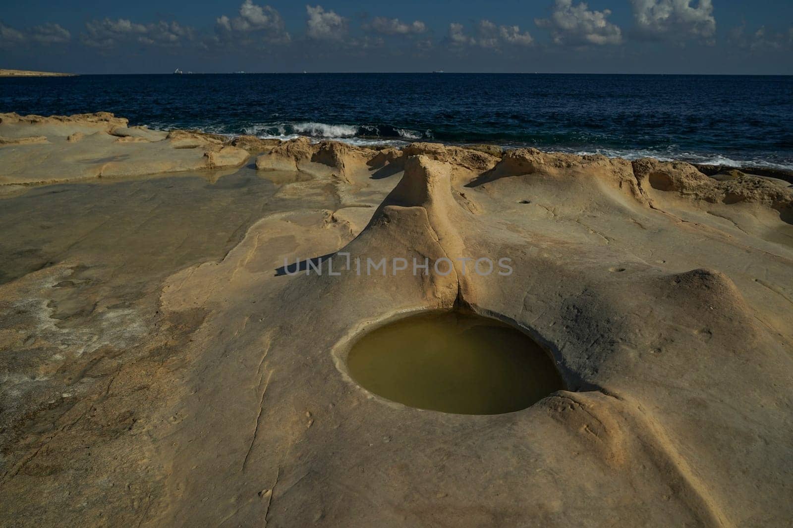 saint peter pools Malta rock formation hole on rocks by AndreaIzzotti