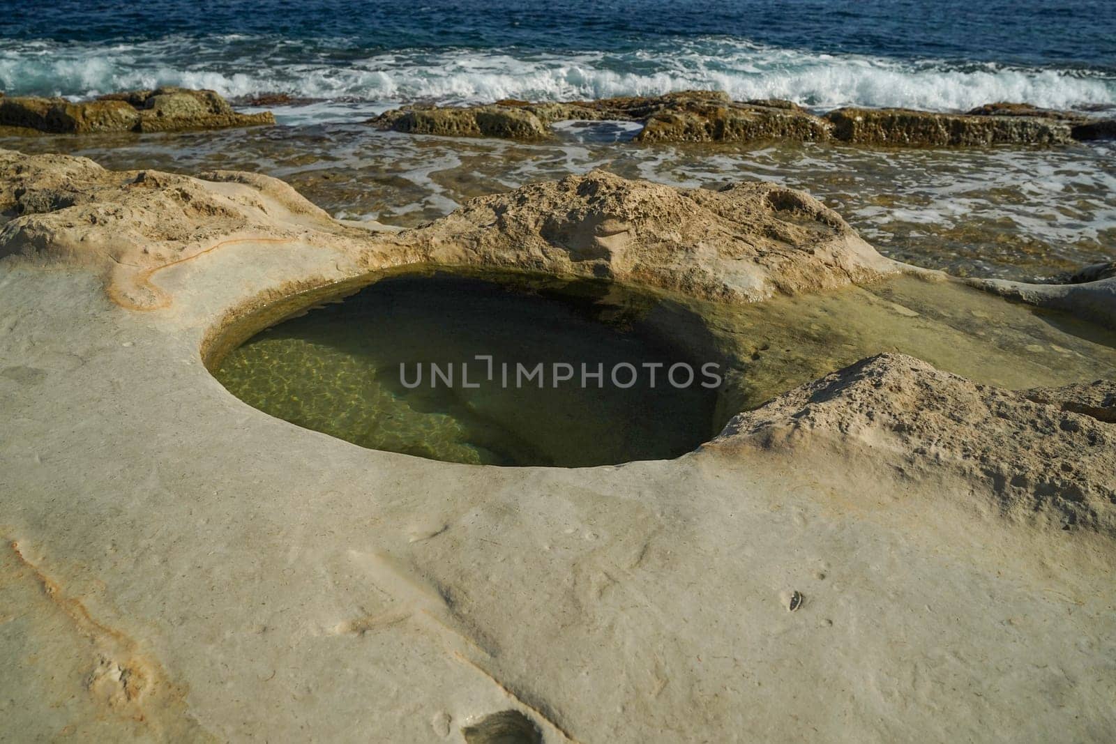 saint peter pools Malta rock formation hole on rocks by AndreaIzzotti