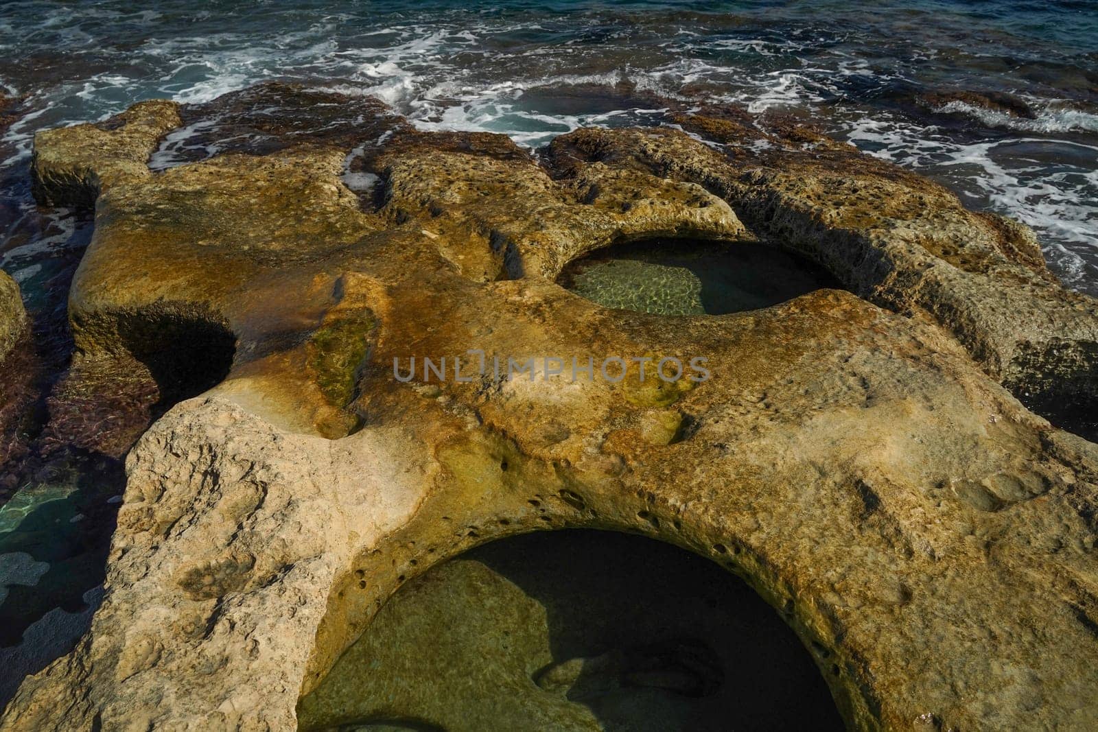 saint peter pools Malta rock formation hole on rocks by AndreaIzzotti